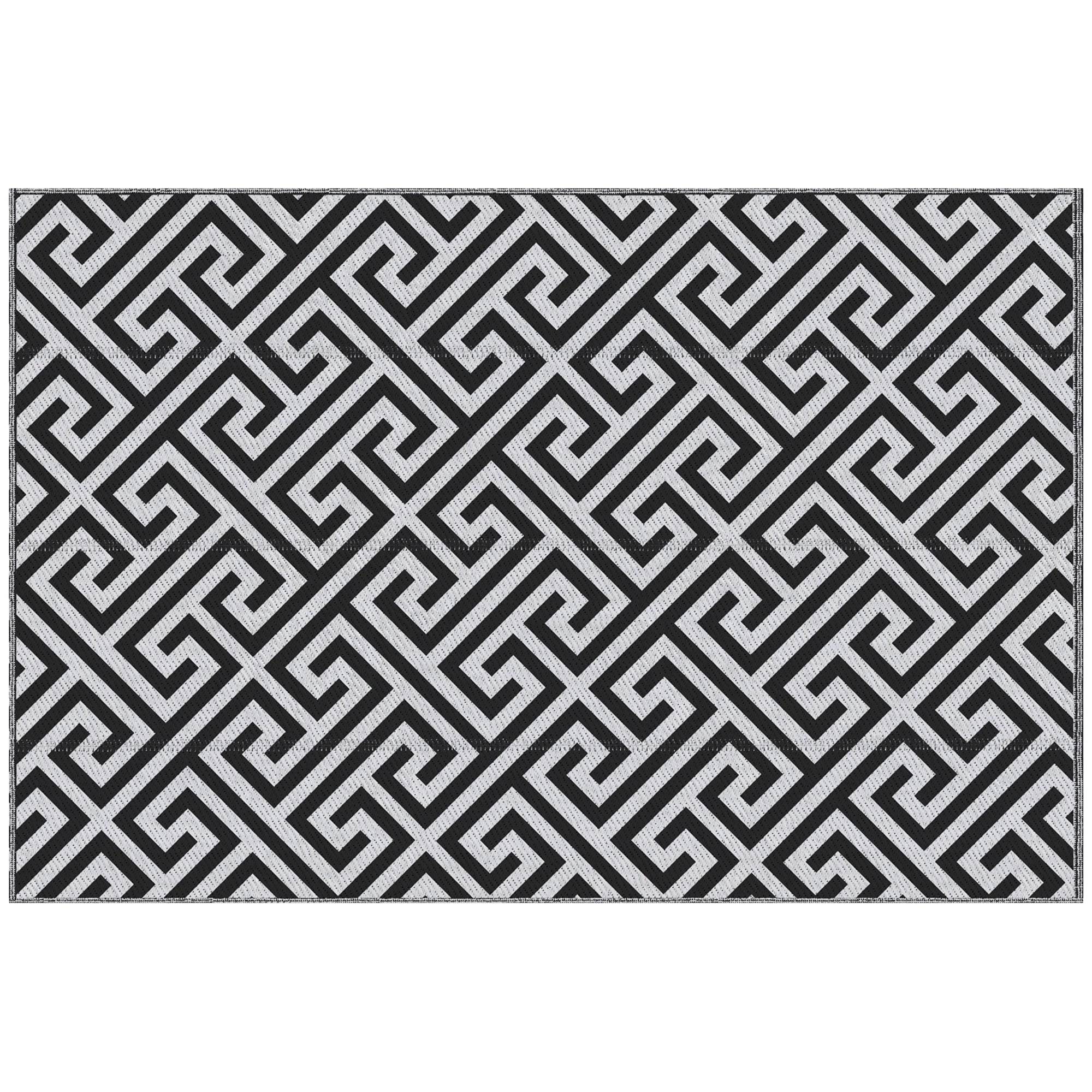 Black and white geometric patterned rug on a white background