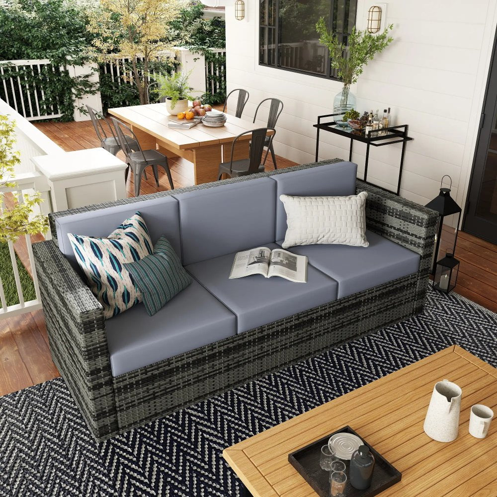 Outdoor patio with wicker sofa, coffee table, and dining area.