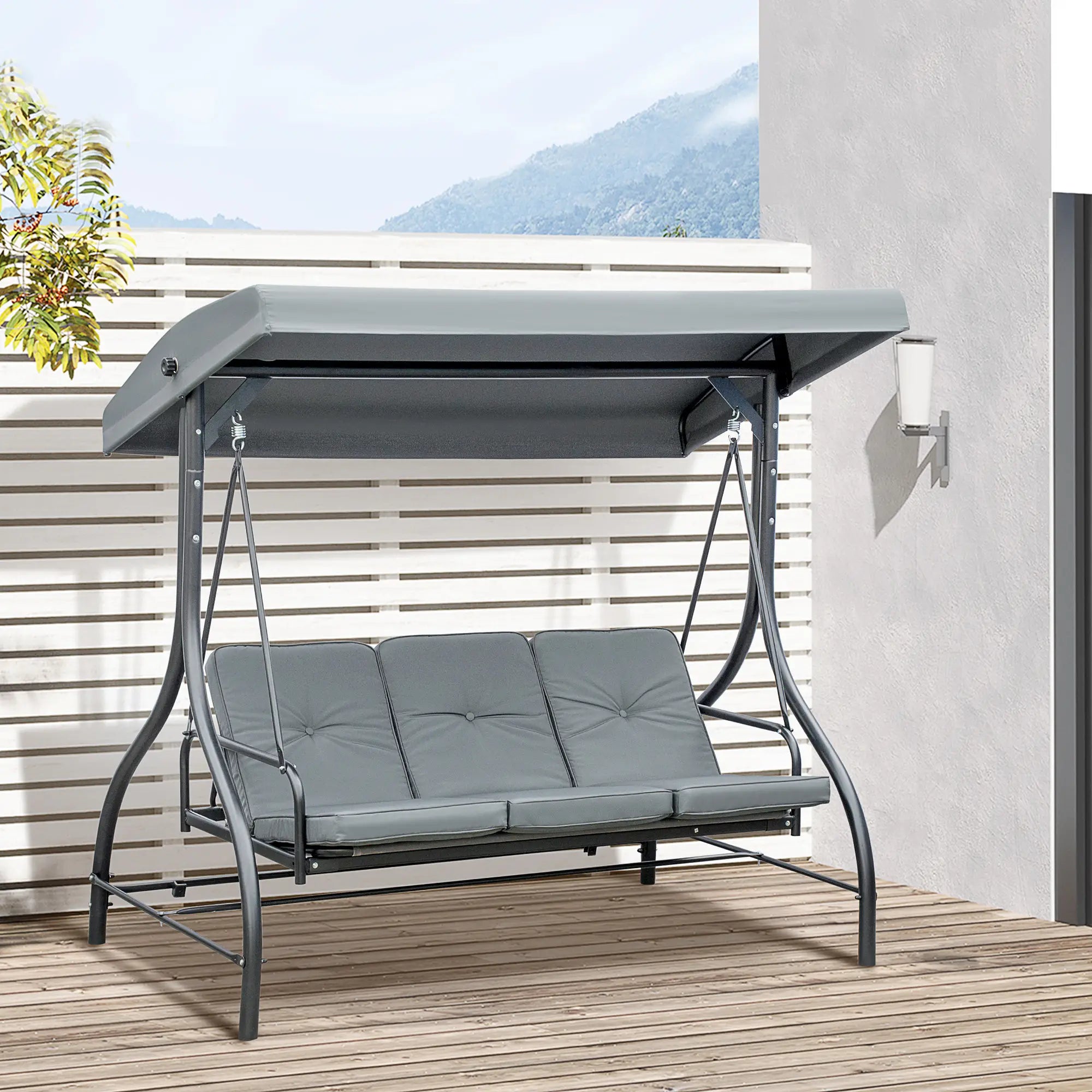 Gray outdoor swing with canopy on a wooden deck