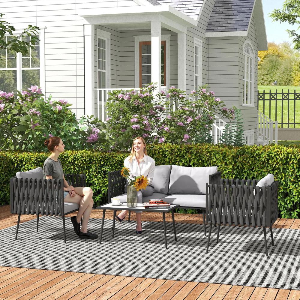 Two women sitting on a patio set with a house in the background