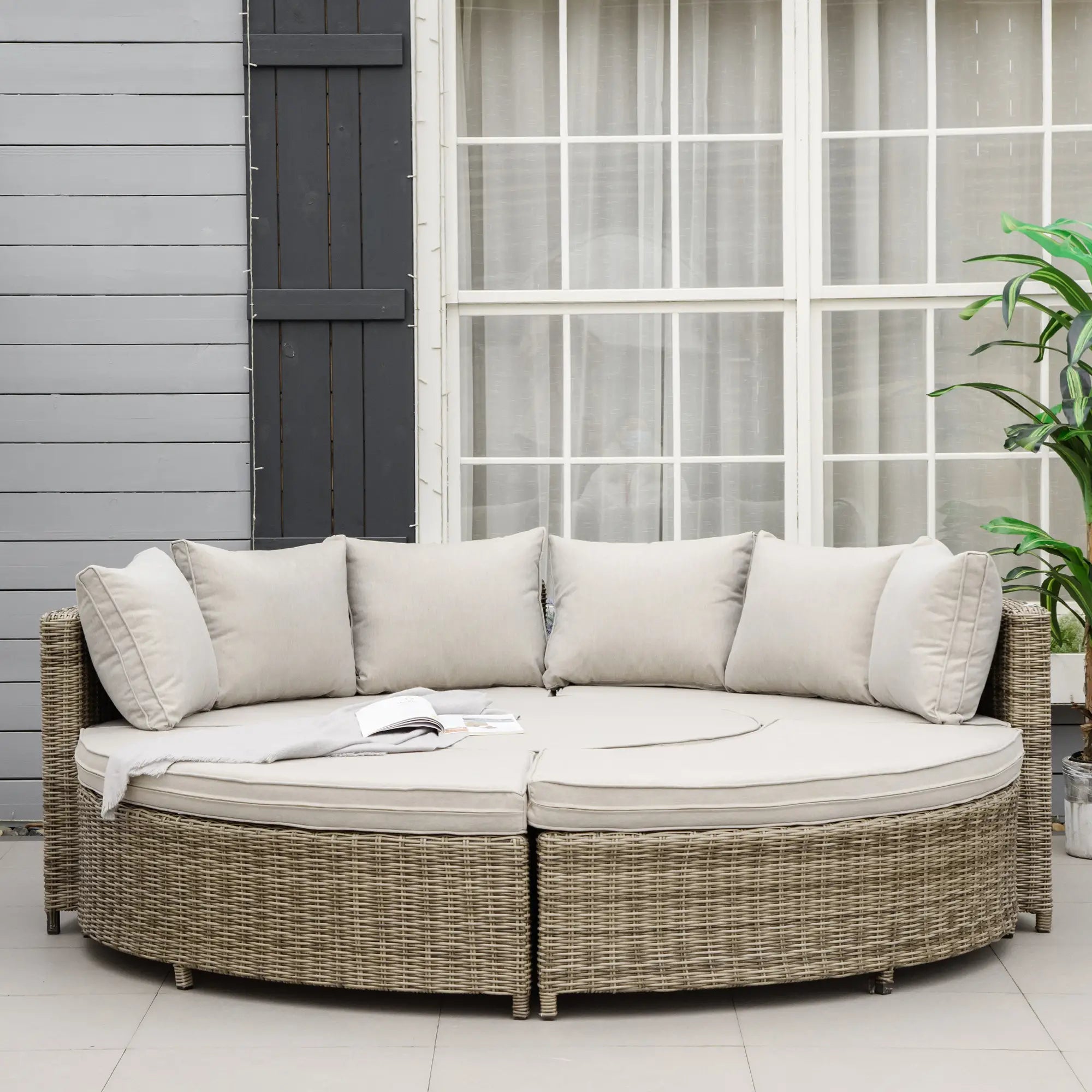 Round outdoor sofa with cushions on a patio