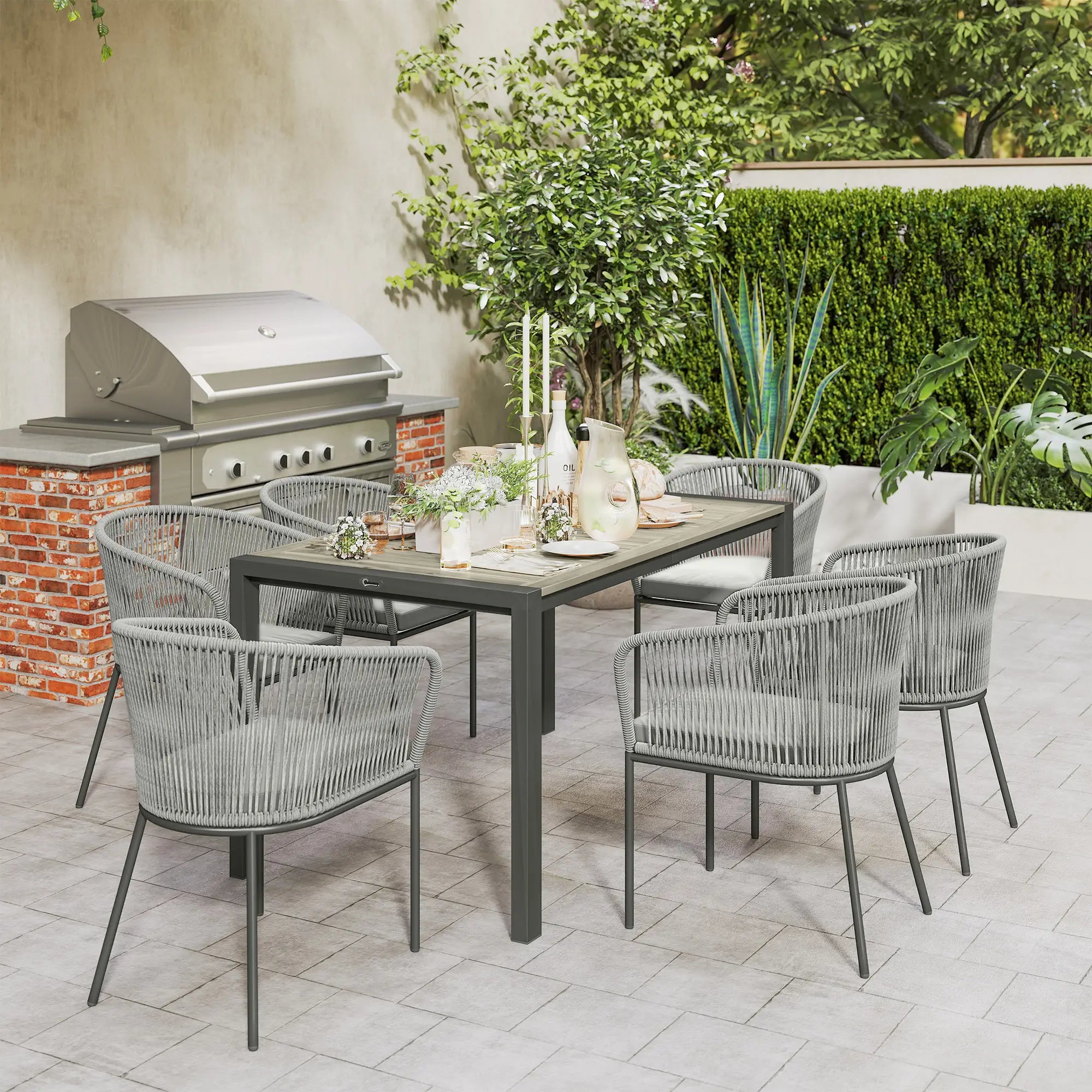 Outdoor dining set with table and chairs on a patio, featuring a grill and plants.