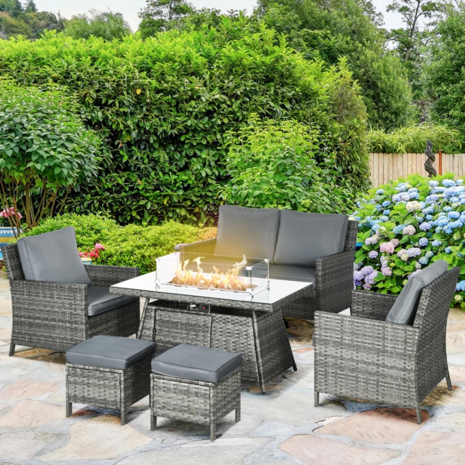 Outdoor patio set with fire pit table in a garden setting