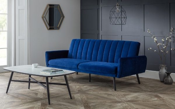 Blue sofa in a modern living room with a coffee table and decorative elements.