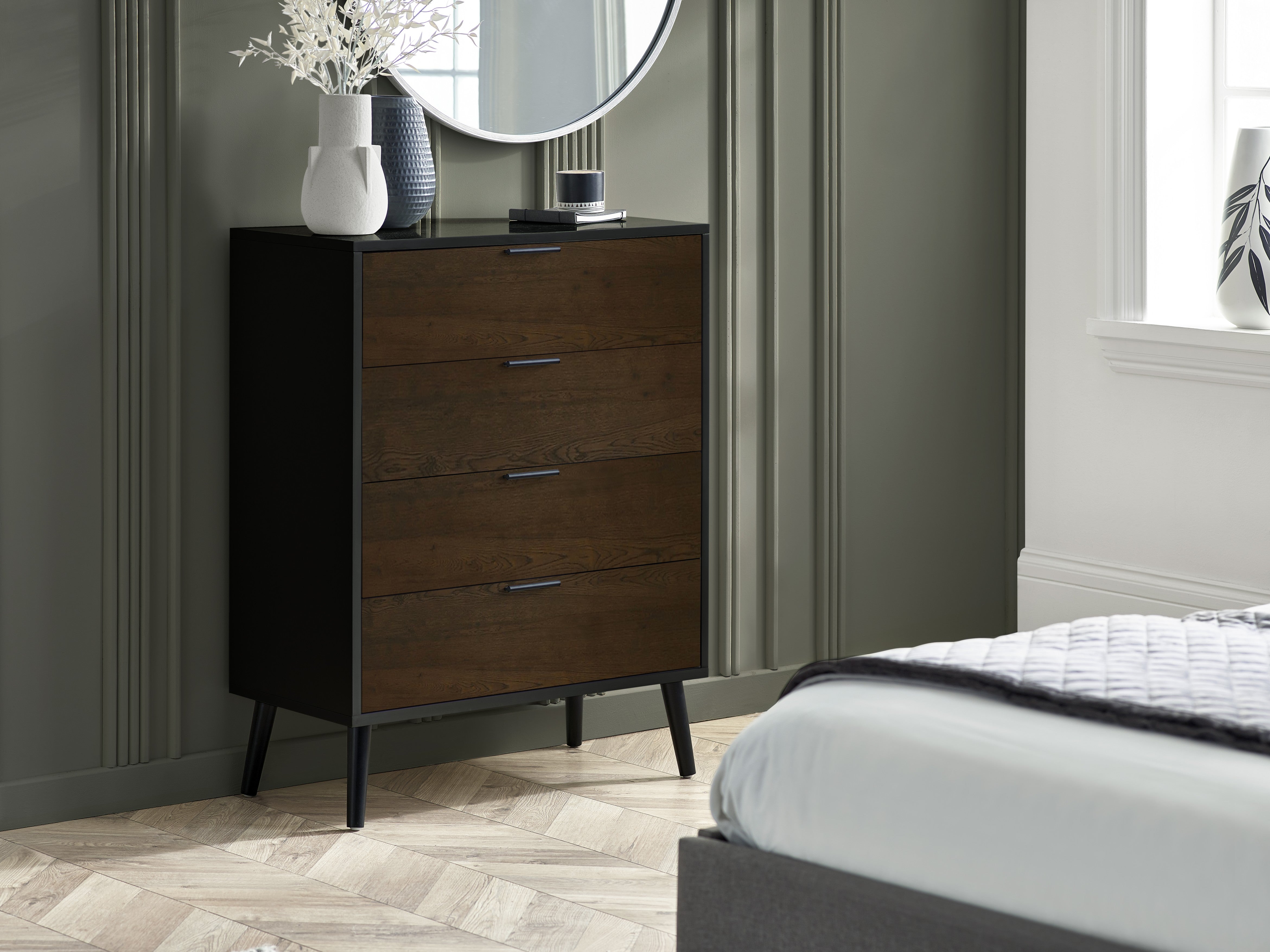 Wooden dresser with three drawers in a bedroom setting.