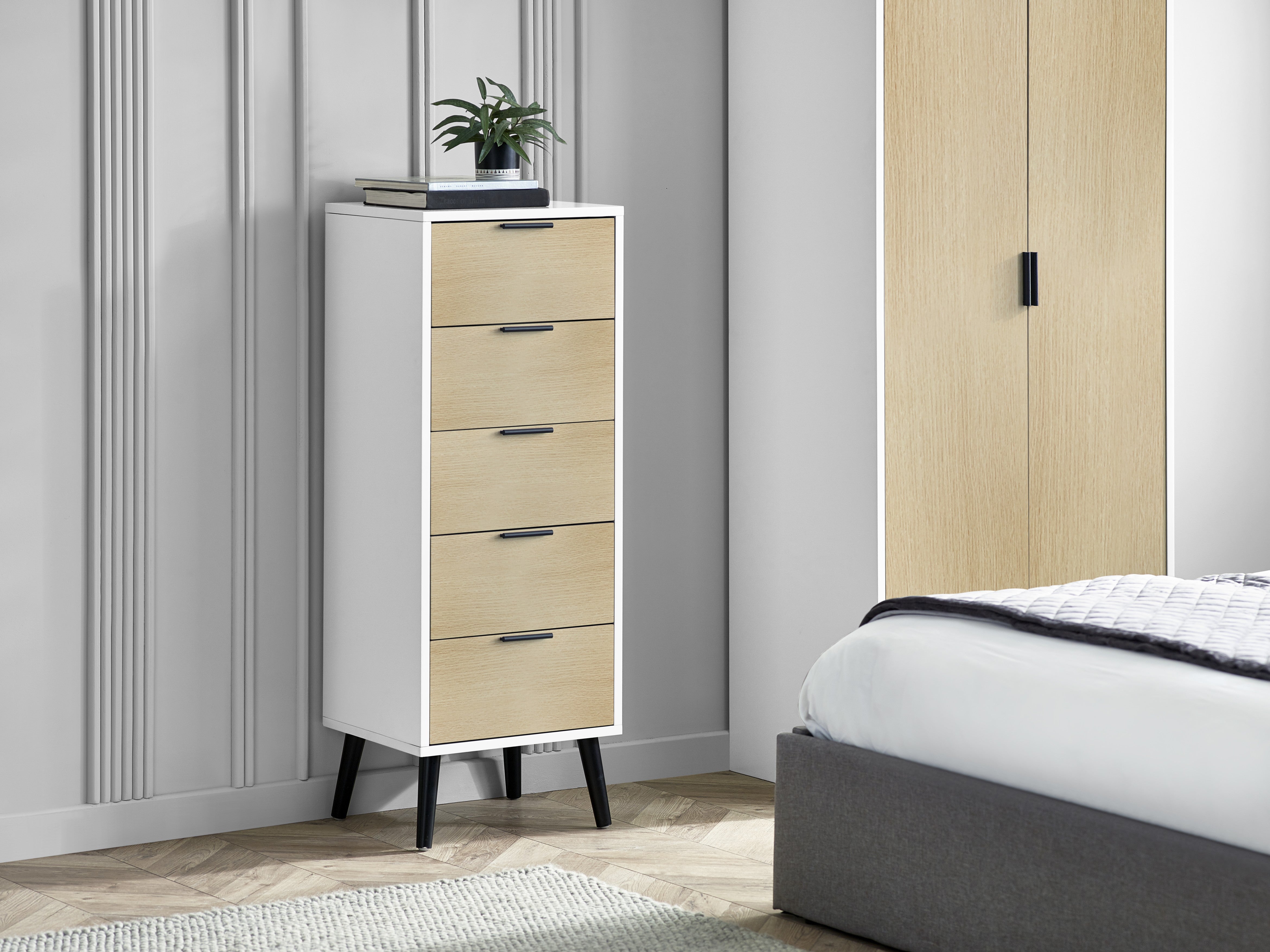 Tall white dresser with beige drawers in a bedroom setting.