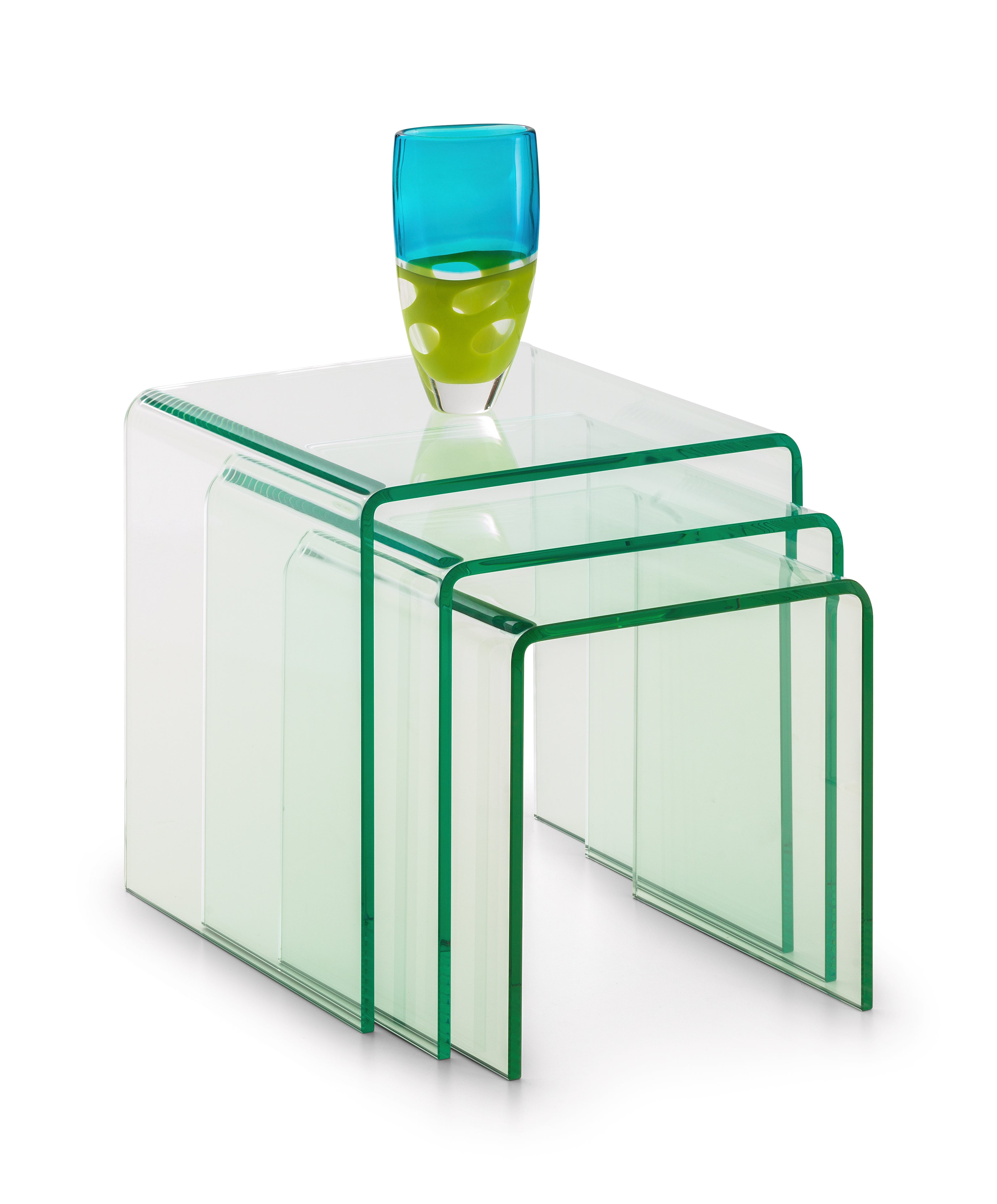 Set of clear glass nesting tables with a blue and green glass vase on top.