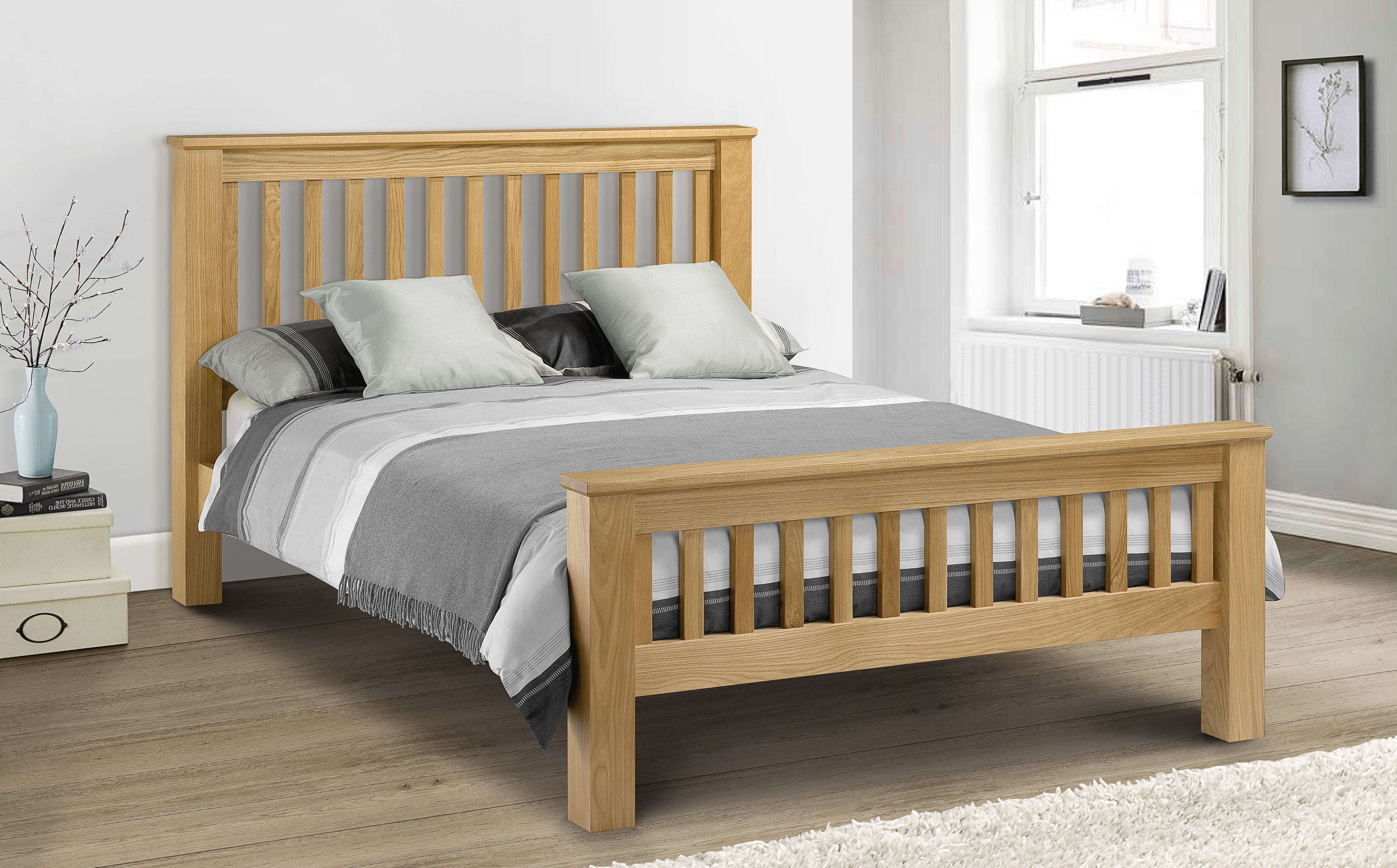Wooden bed with bedding in a bedroom setting