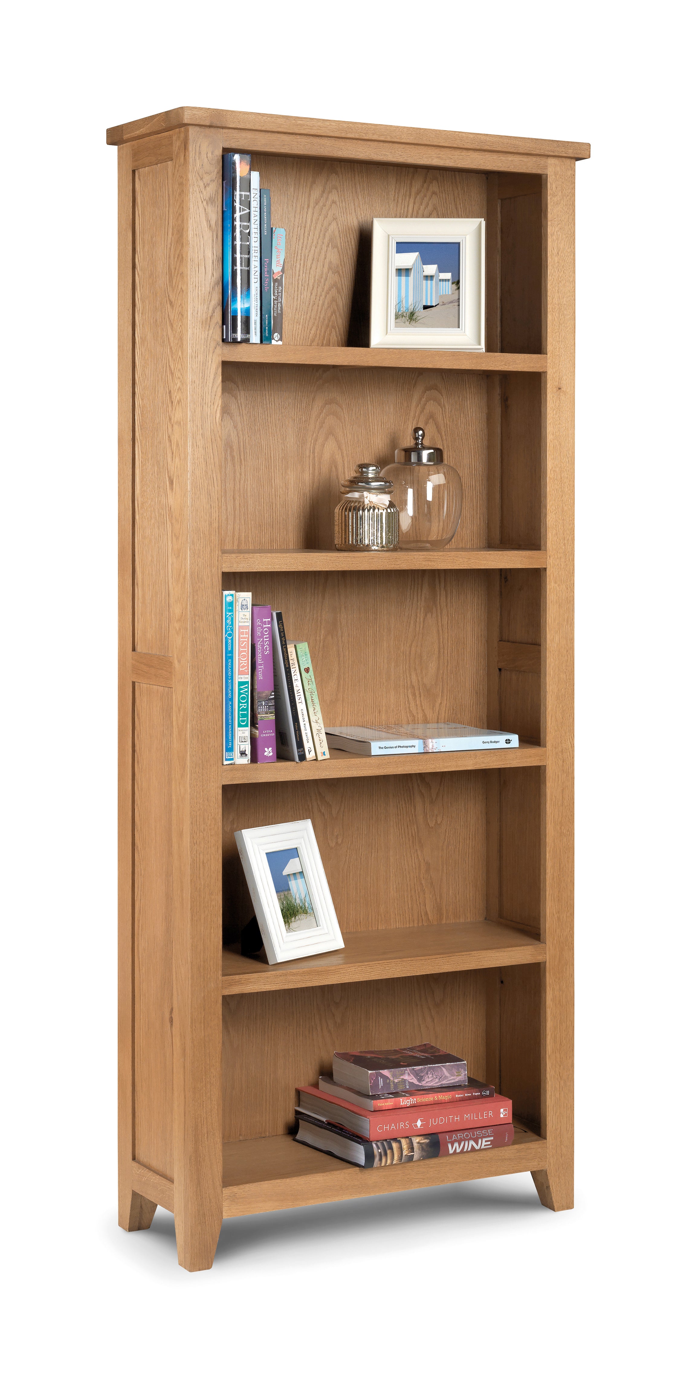 Wooden bookshelf with books and decorative items on a white background