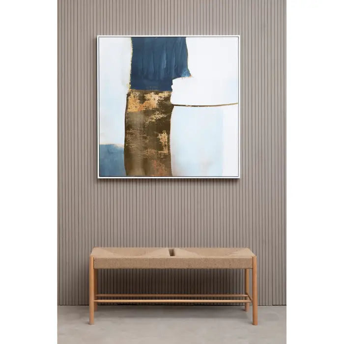 Abstract art piece on a wall above a wooden console table.