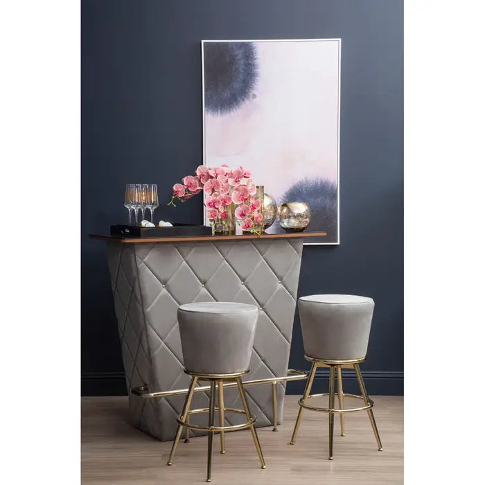 Gray bar with stools and decorative items against a dark blue wall.