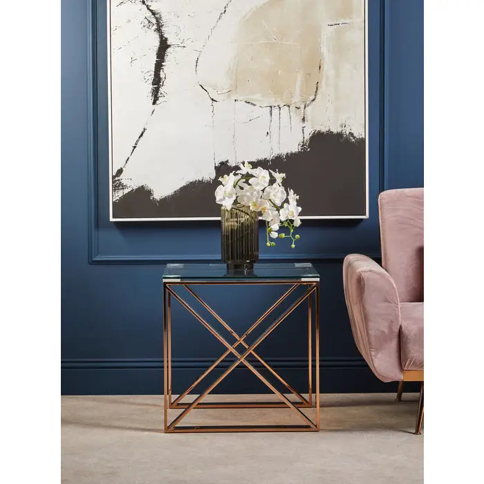 Modern interior with abstract art, glass table, and pink chair.