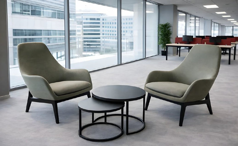 Modern office chairs and tables in a bright, open-plan office setting.