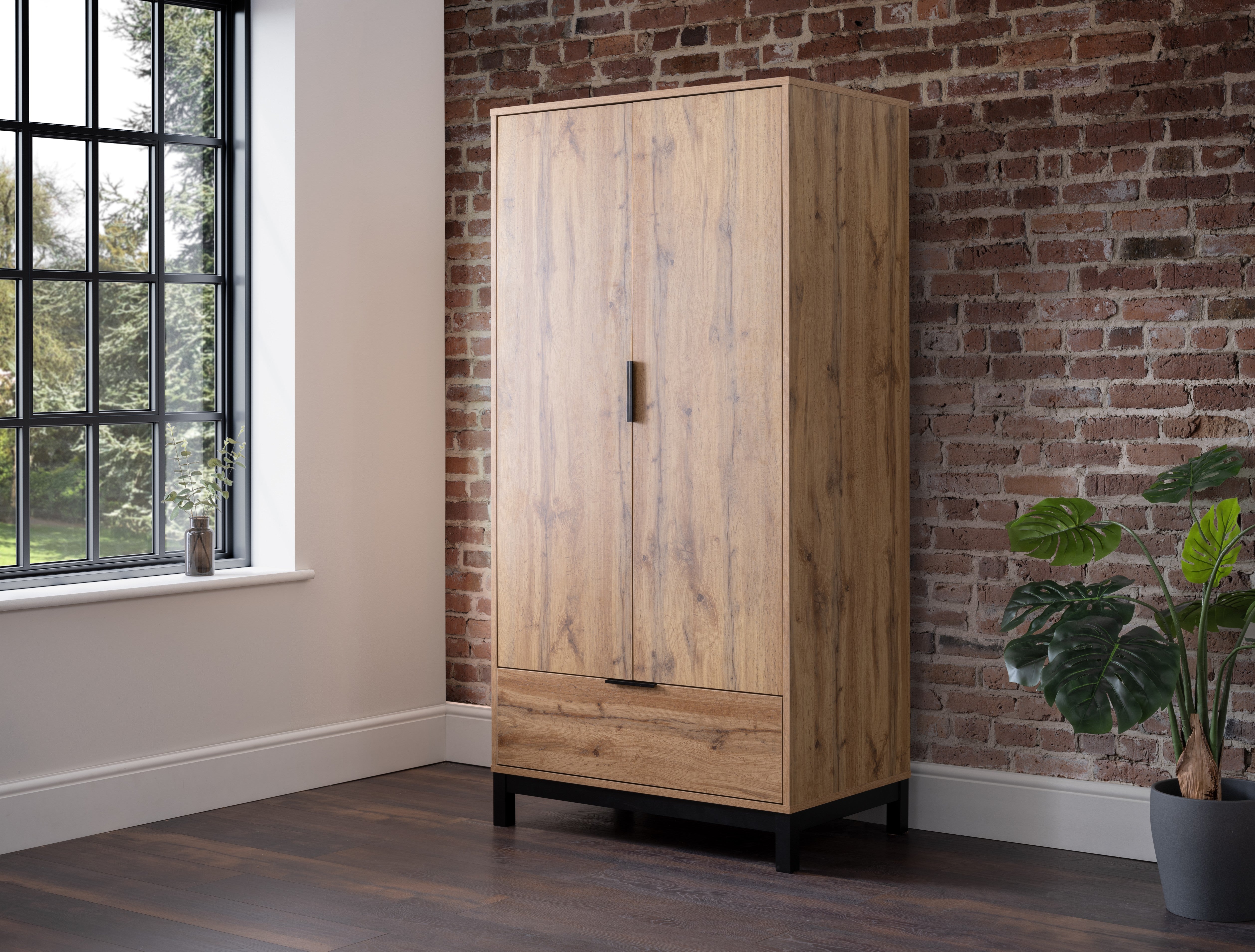 Wooden wardrobe against a brick wall with a window in the background