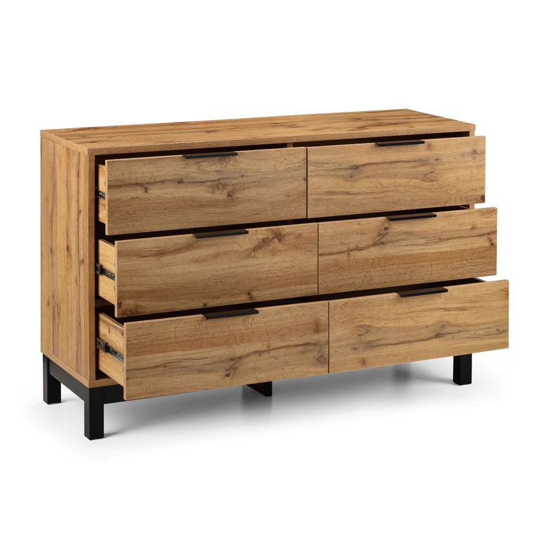 Wooden dresser with multiple drawers on a white background