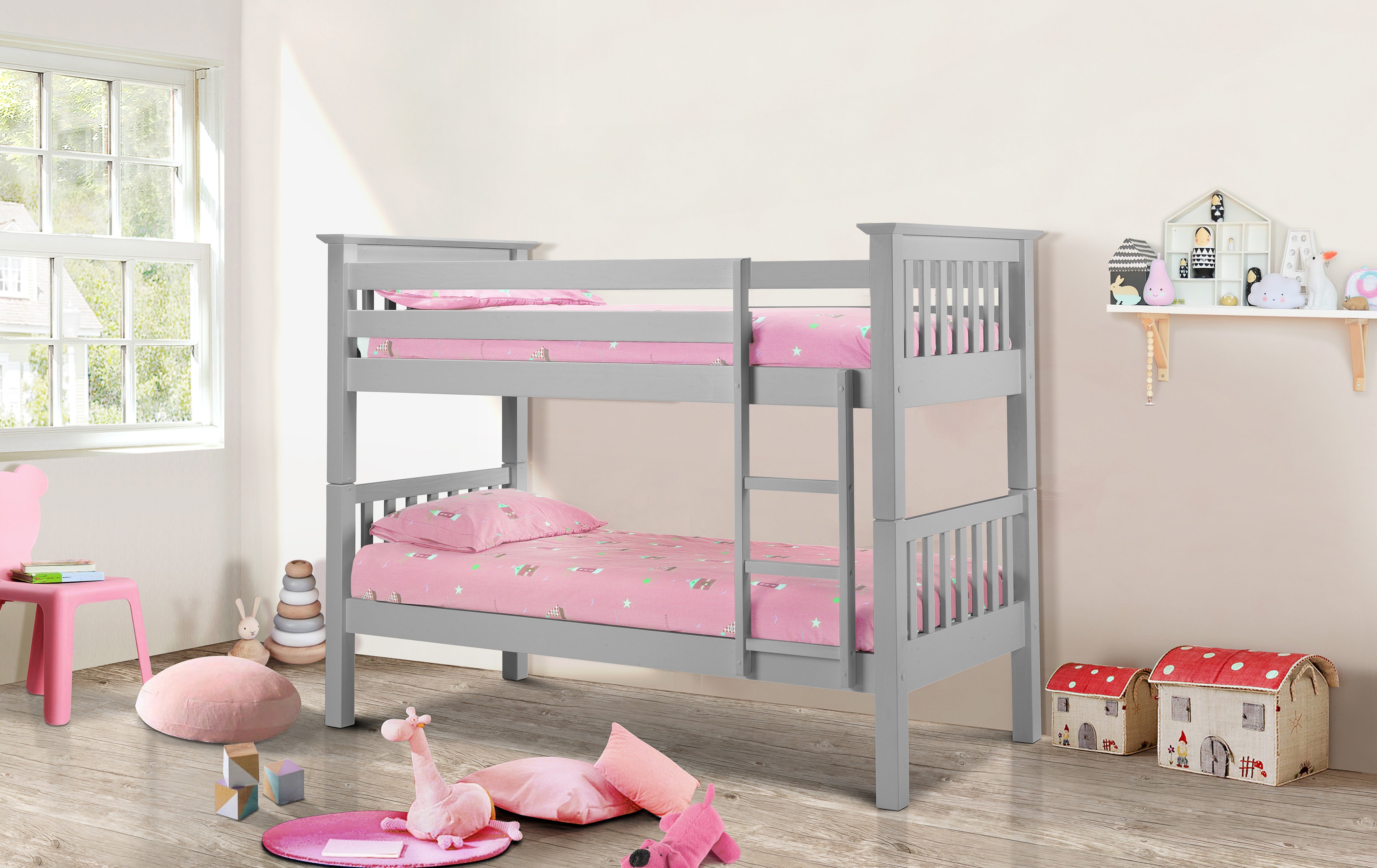 Gray bunk bed with pink bedding in a child's room with toys and furniture.