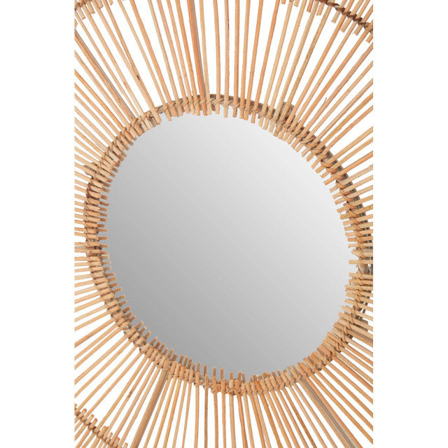 Round mirror with a rattan frame on a white background