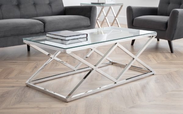Modern coffee table with glass top and metal frame in a living room setting.