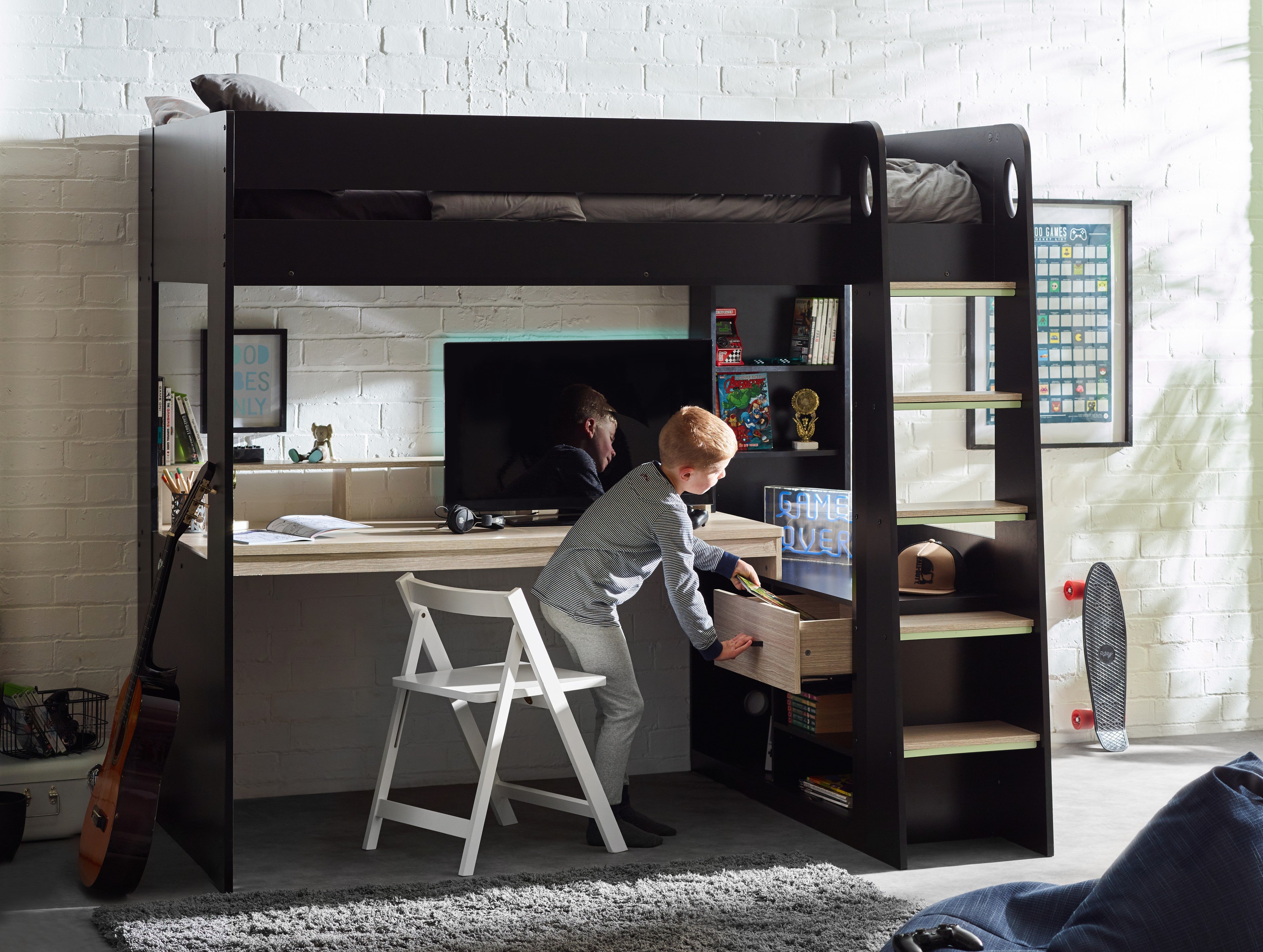 Child using a loft bed with desk space in a room with a white brick wall.