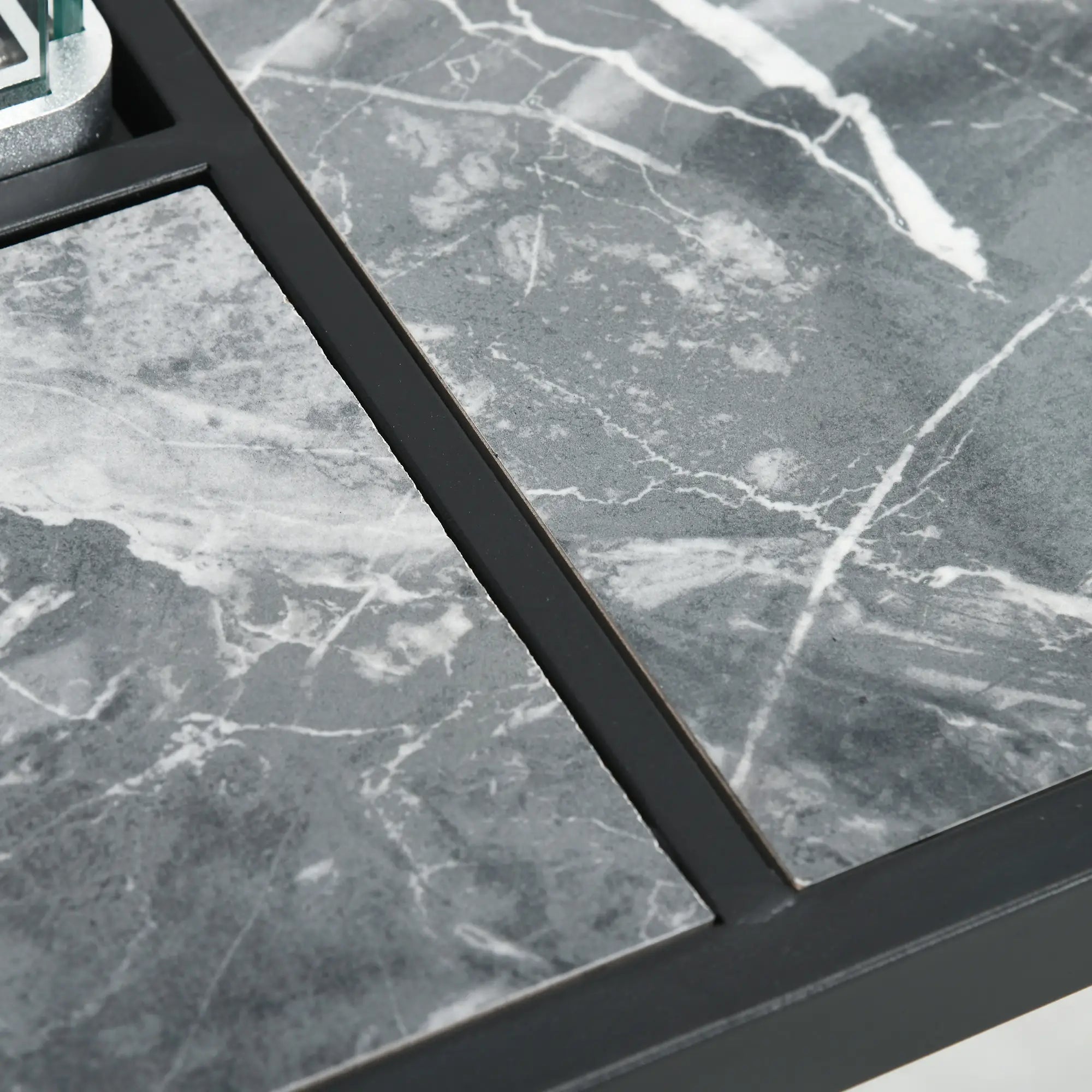 Close-up of gray marble tiles with a black frame