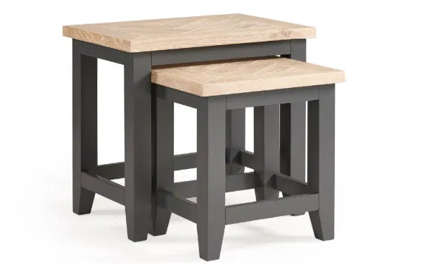 Two wooden nesting tables with gray bases on a white background