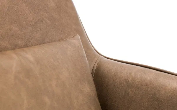 Close-up of brown leather furniture with a white background