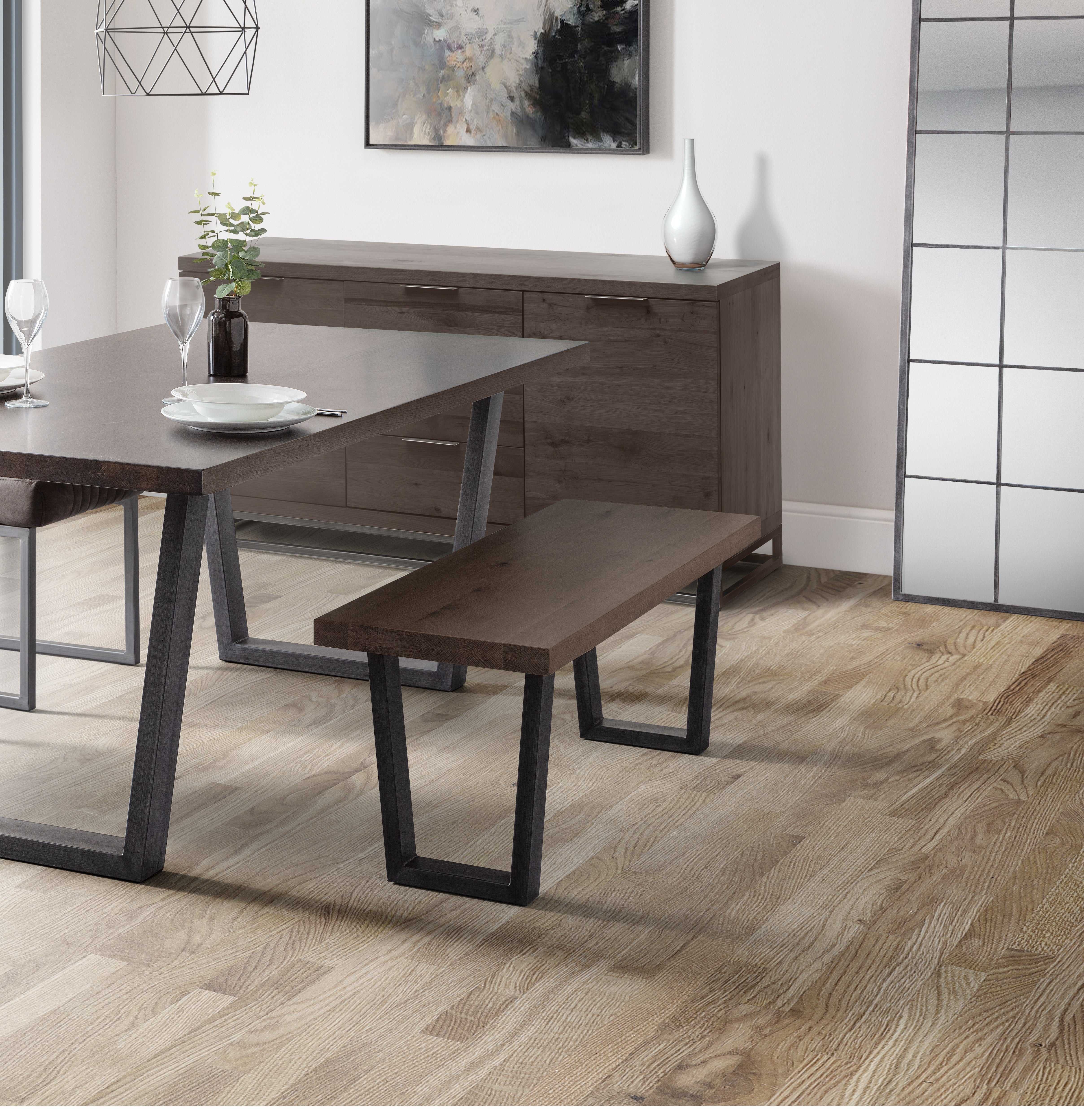 Dining room with wooden table and bench on a wooden floor.