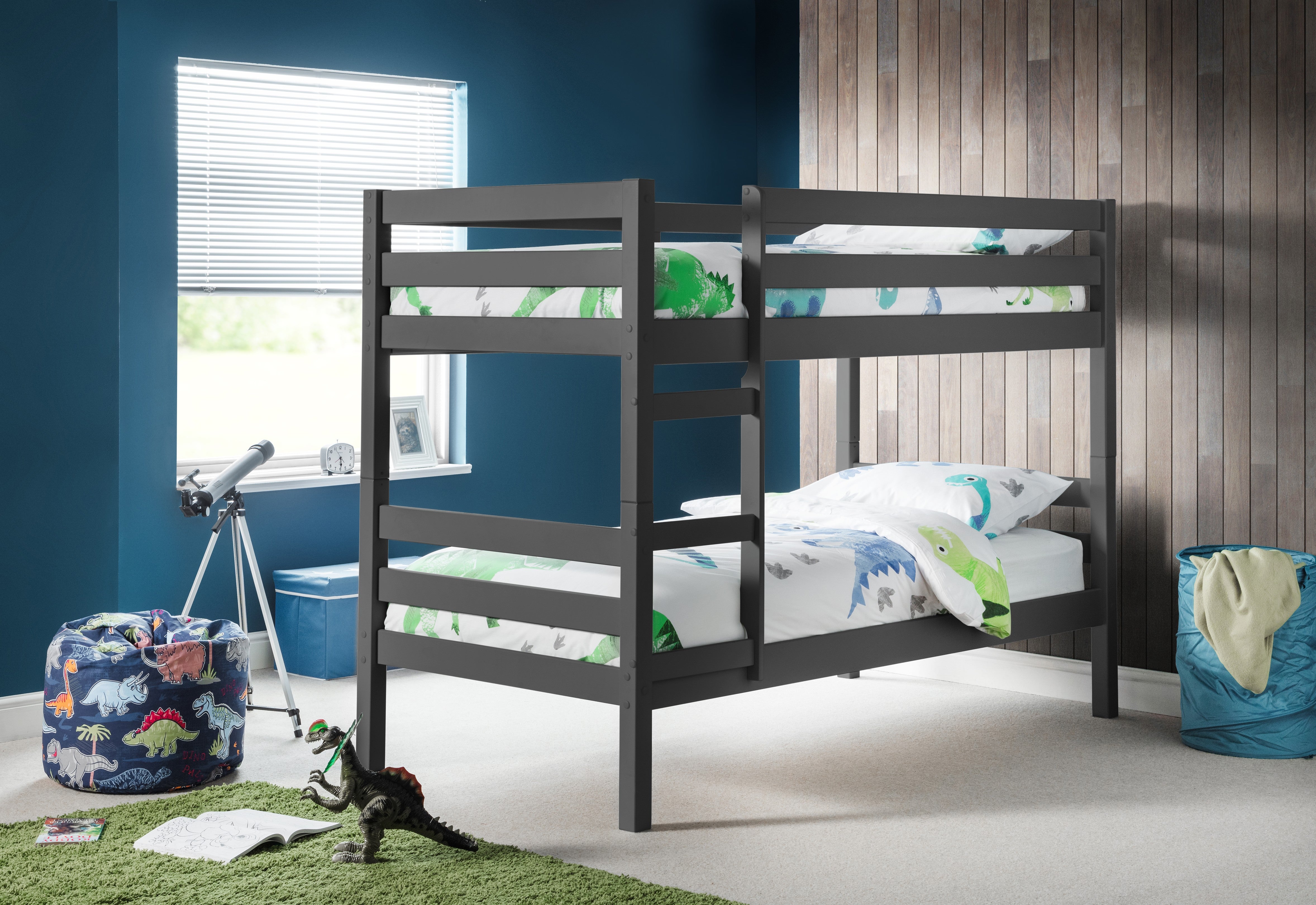 Bunk bed in a child's bedroom with dinosaur-themed bedding and toys.