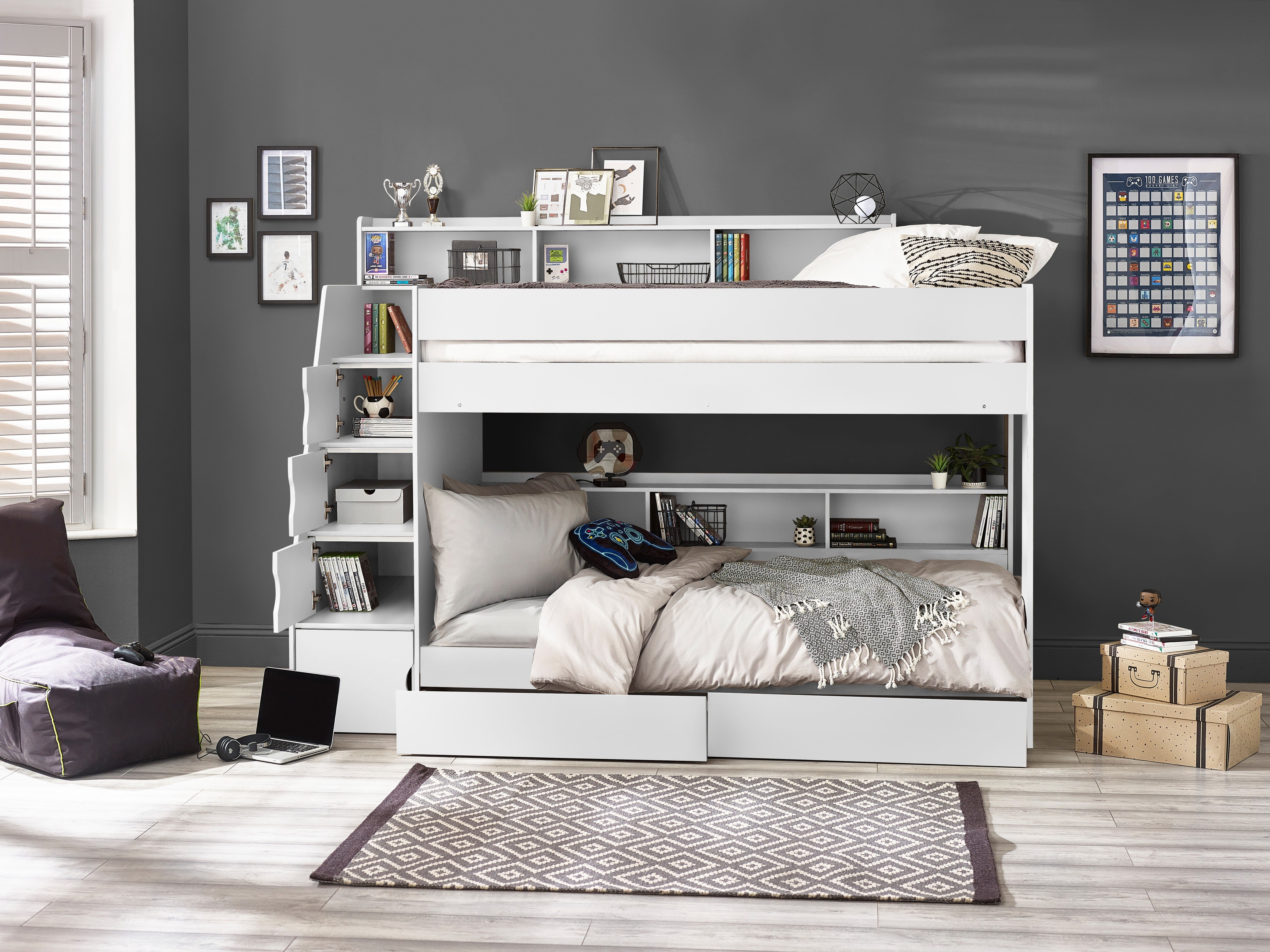 White bunk bed in a room with gray walls, books, and decorative items.