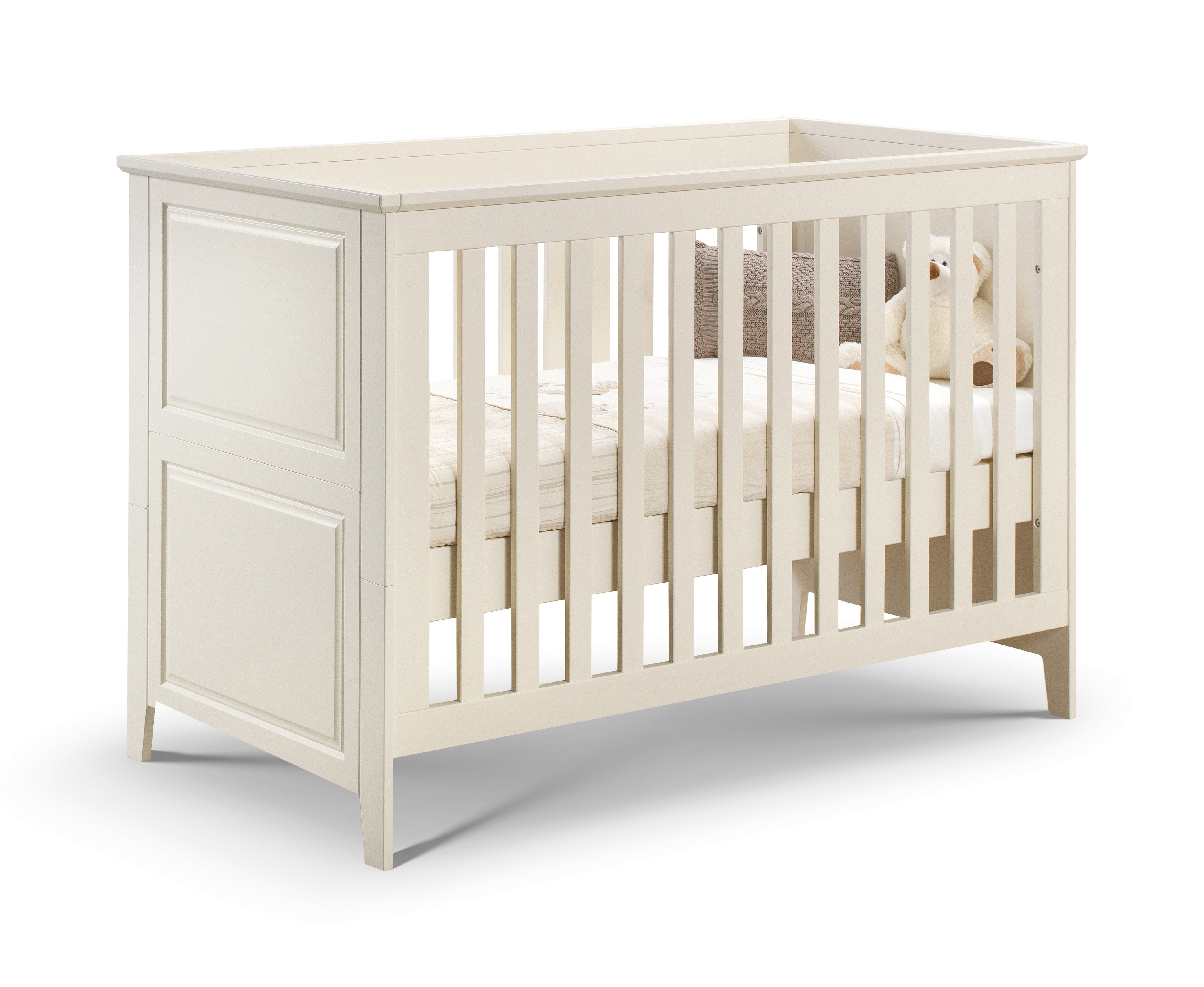 White crib with a teddy bear on a white background