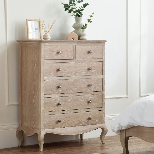 Wooden dresser with decorative items against a white wall