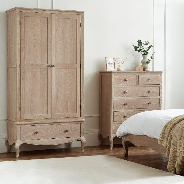 Wooden wardrobe and chest of drawers in a bedroom setting.