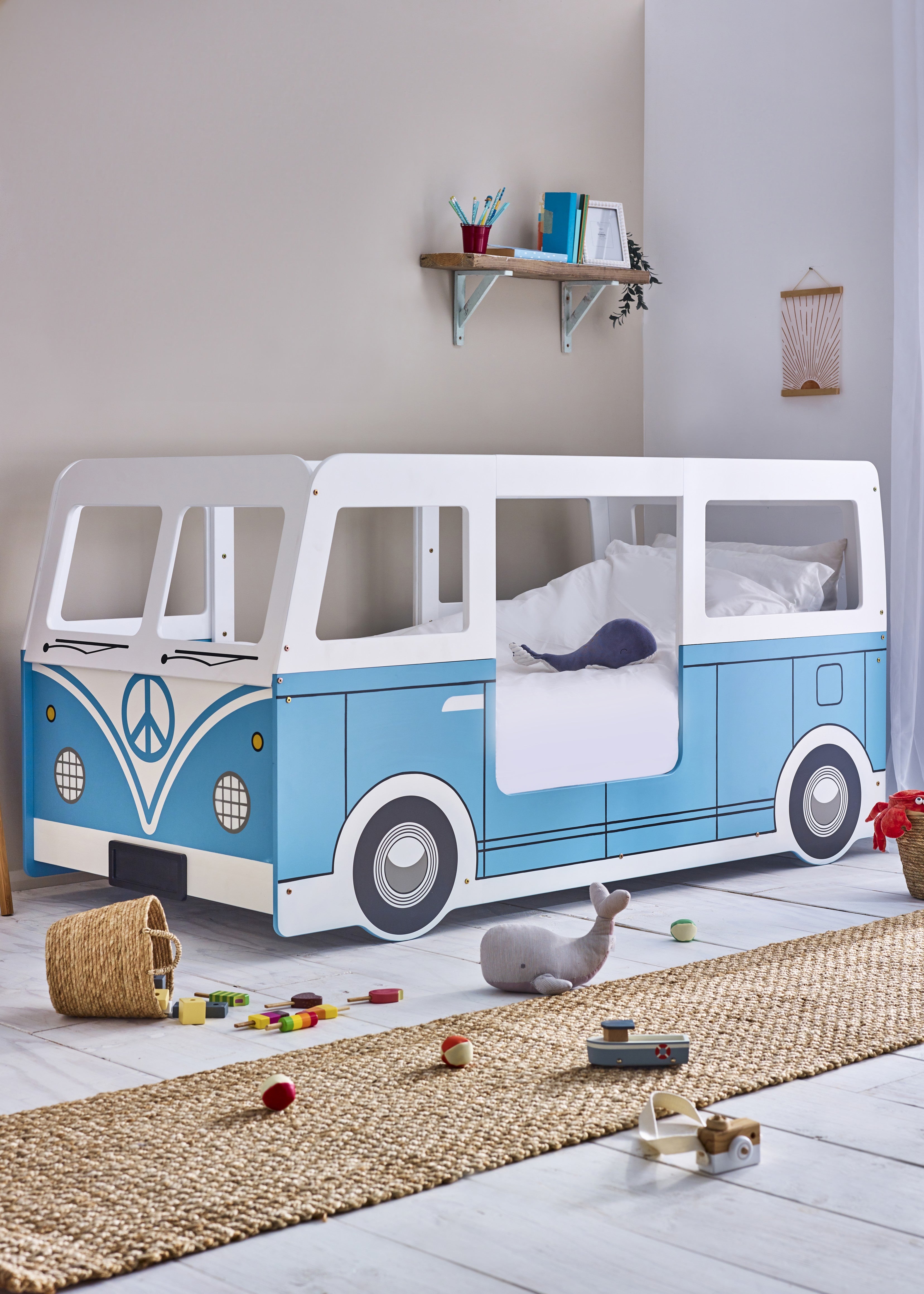 Children's room with a blue and white bus-shaped bed.