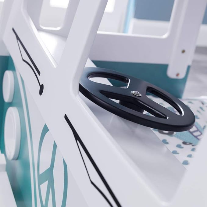 Close-up of a white and black steering wheel on a vehicle, with a blurred background.