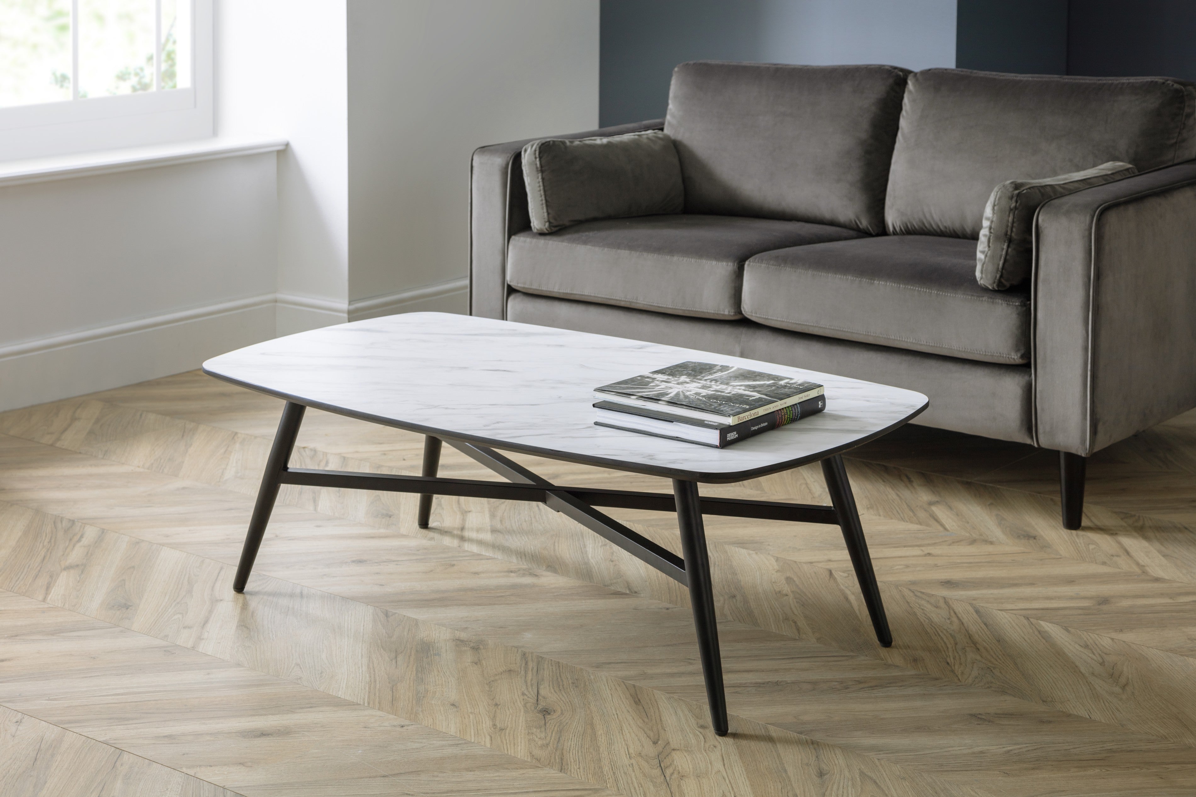 Gray sofa with a coffee table in a room with wooden flooring