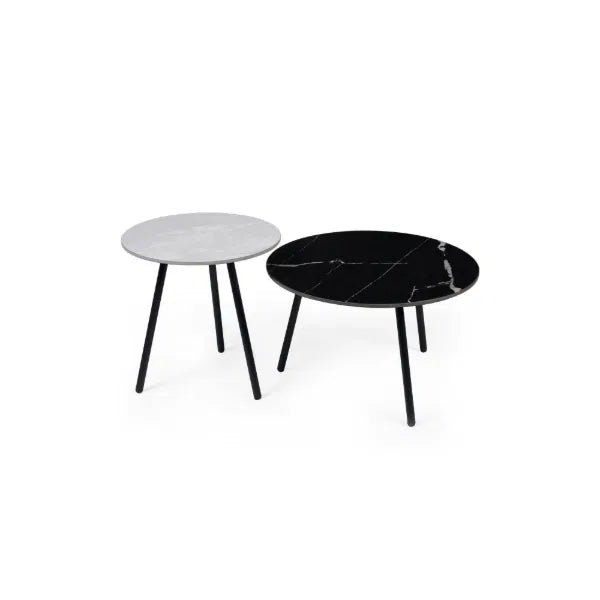 White and black cirular tables on a white background.