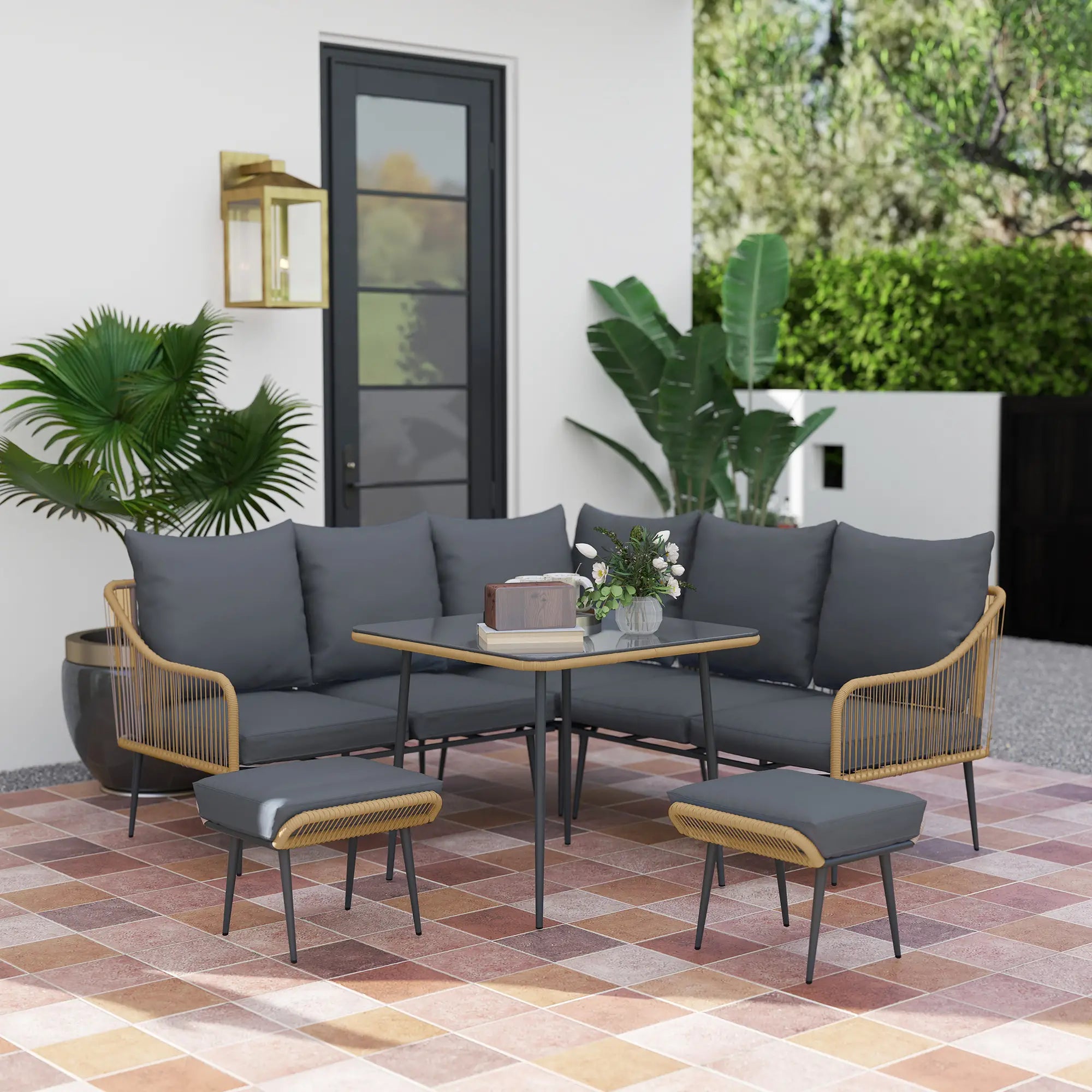 Outdoor patio set with gray cushions and wooden frames on a tiled patio.