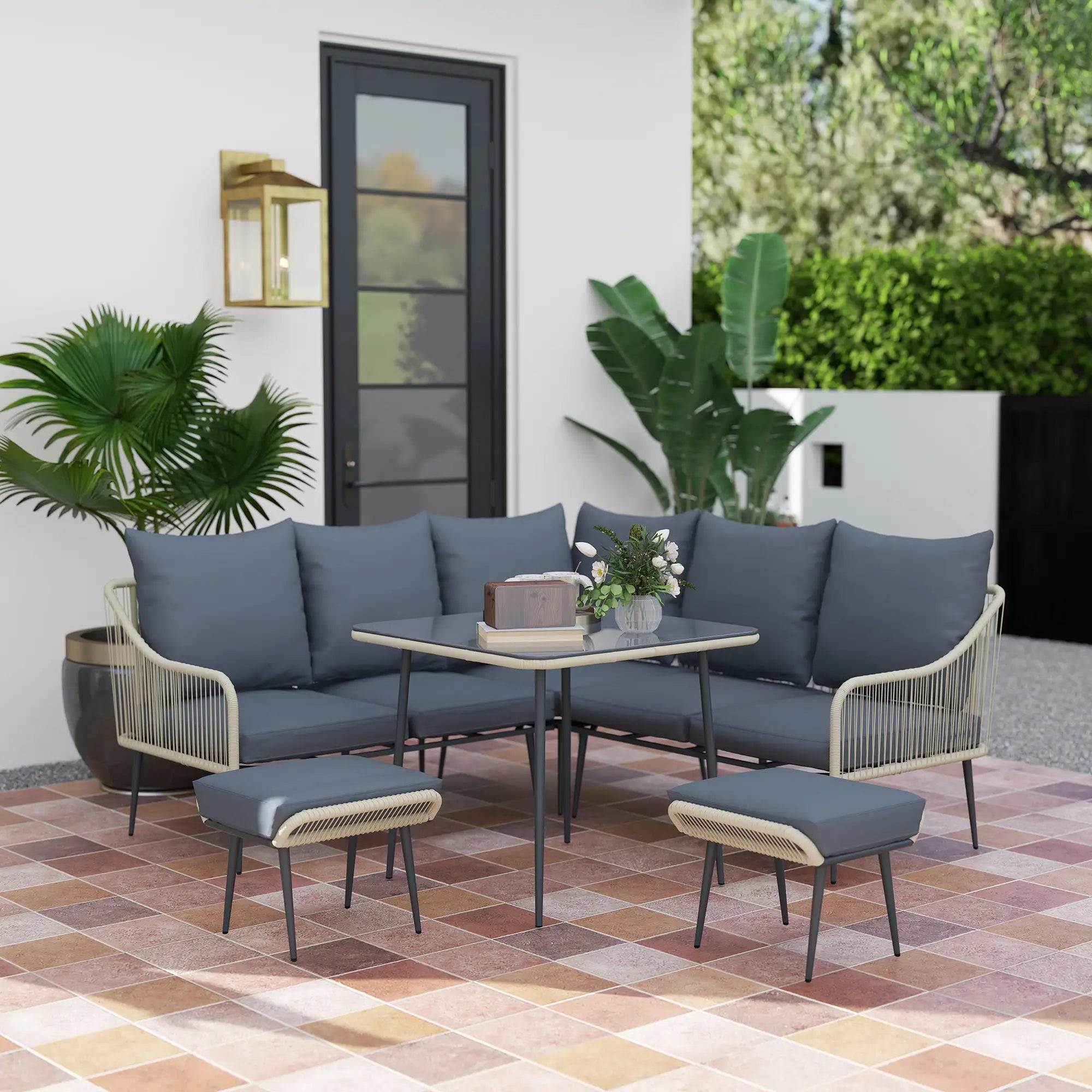 Outdoor patio set with gray cushions and a small table on a tiled patio.