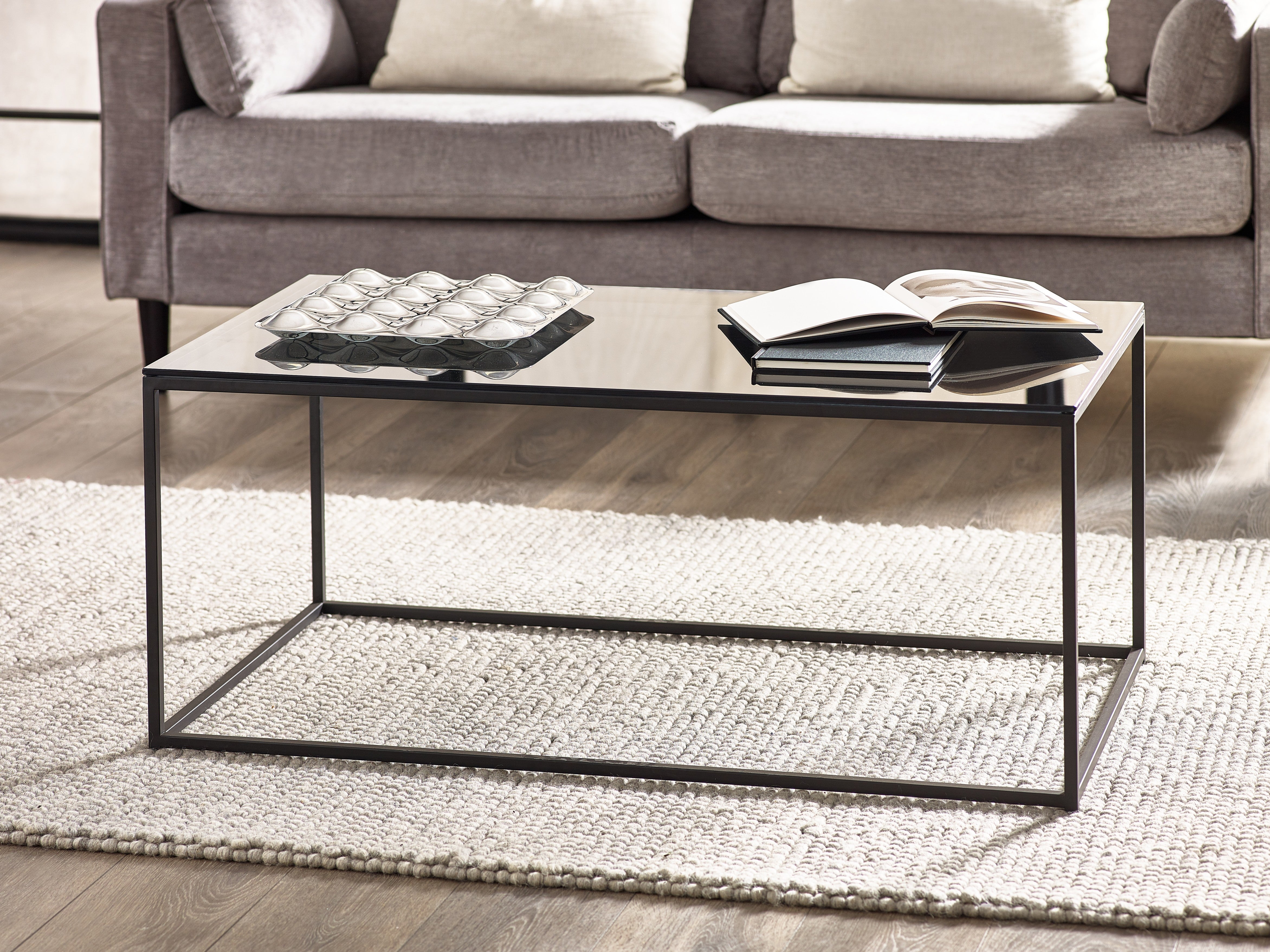 Coffee table with decorative items in a living room setting
