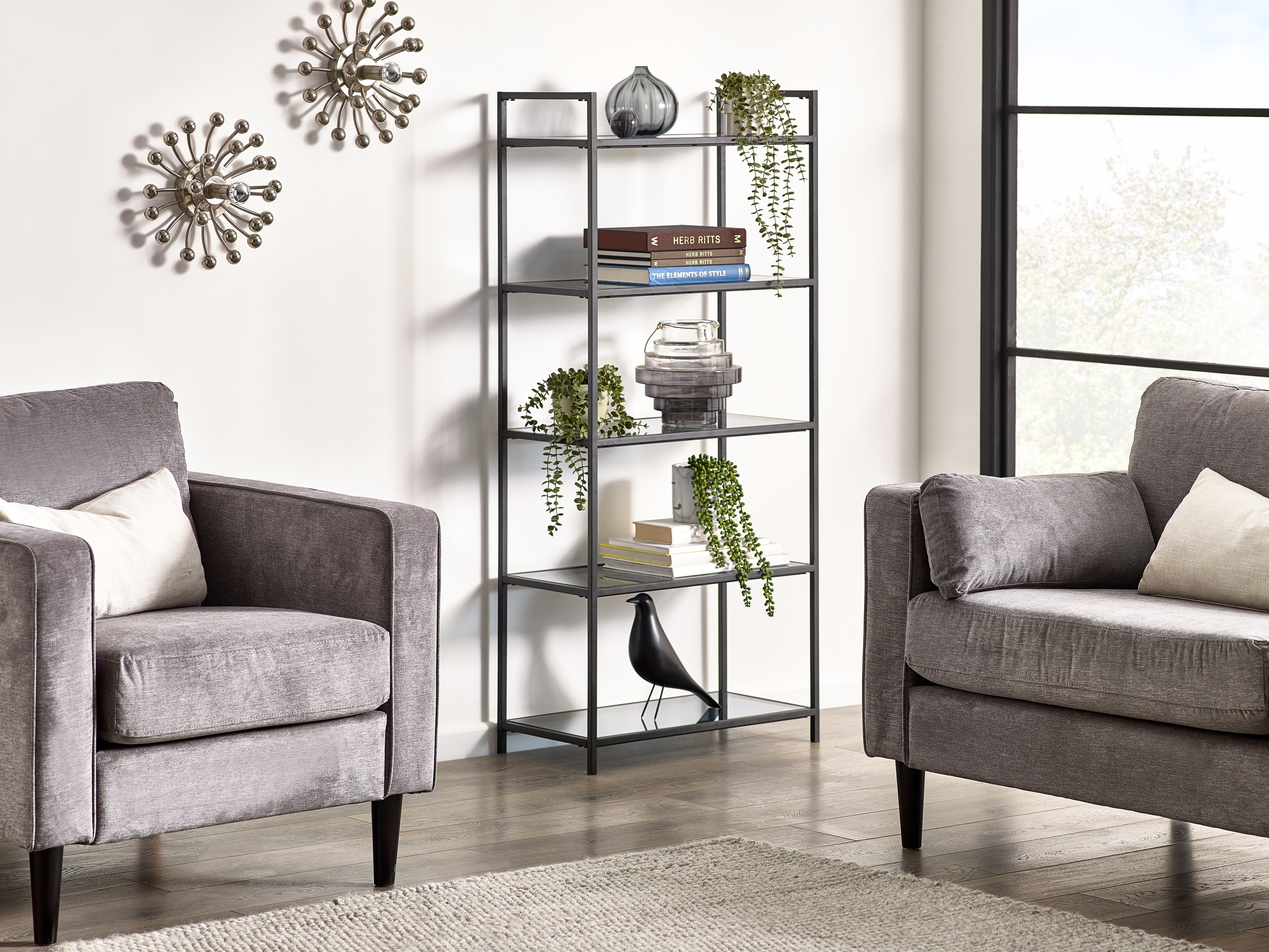 Living room with gray sofa, armchair, and metal shelf.