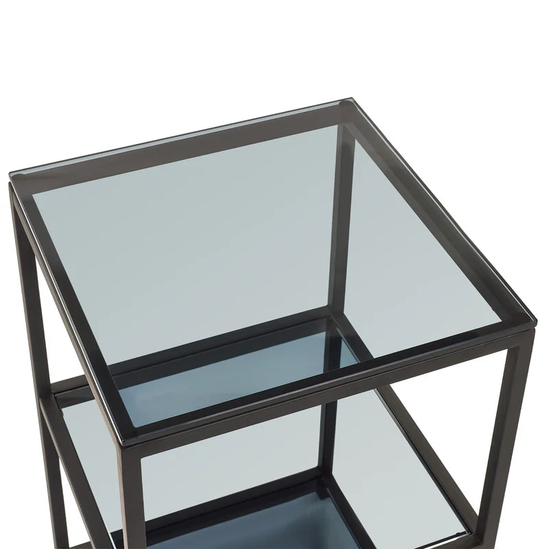 Glass side table with black metal frame on a white background