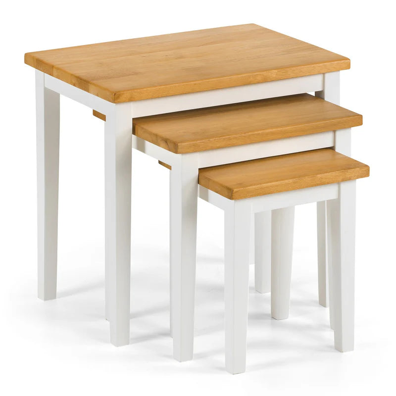 Set of three wooden nesting tables with white bases on a white background