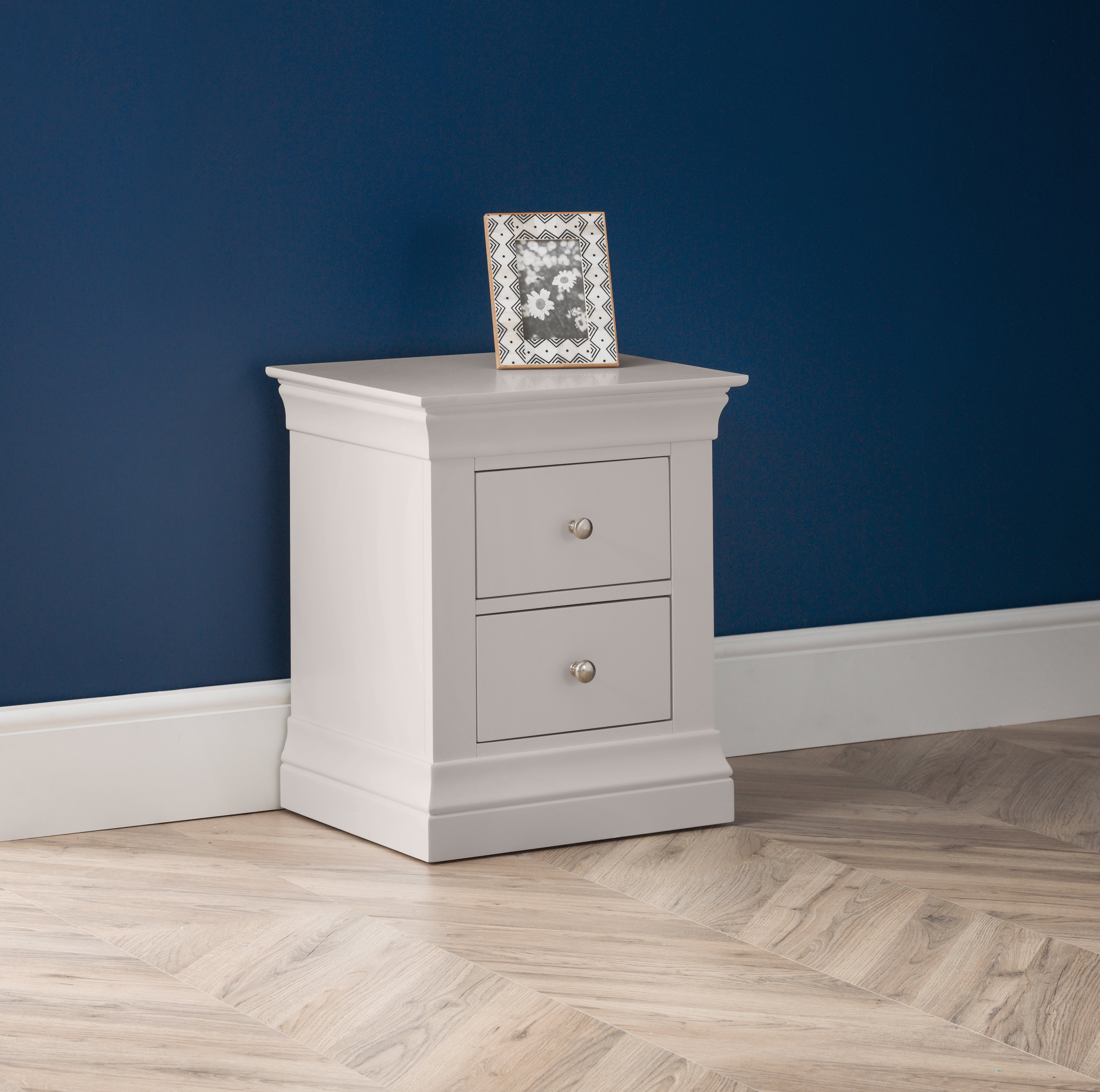 Nightstand with two drawers against a blue wall