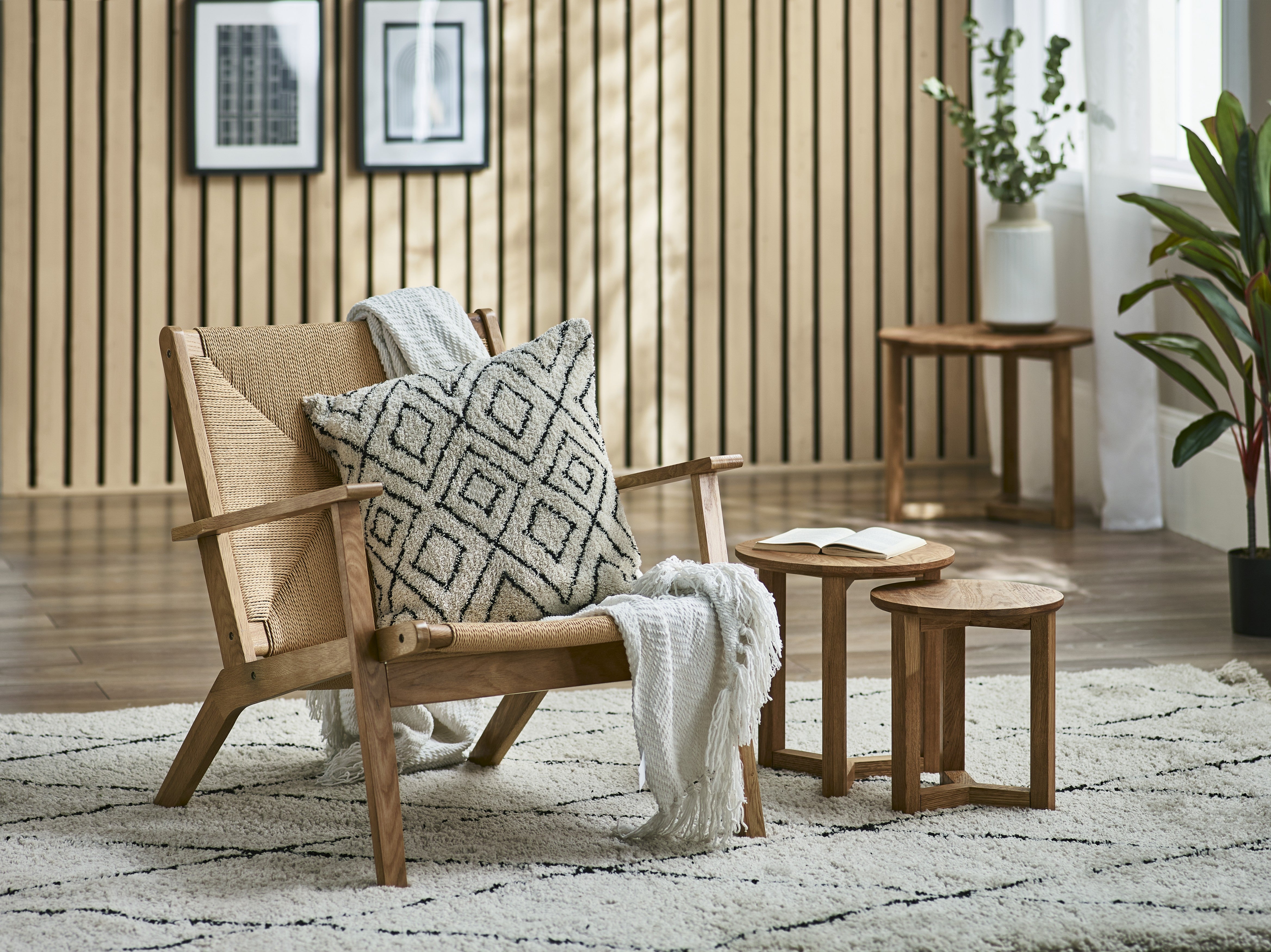 Wooden armchair with patterned pillow in a cozy living room setting