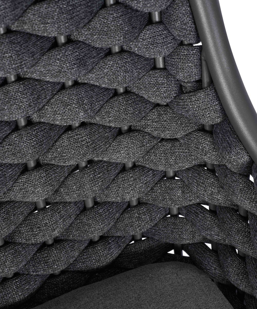 Close-up of a textured gray chair seat with woven pattern