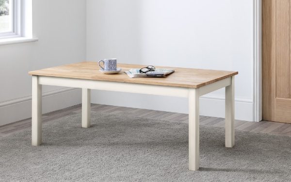 Wooden coffee table with a white base in a room with a window and wooden door.