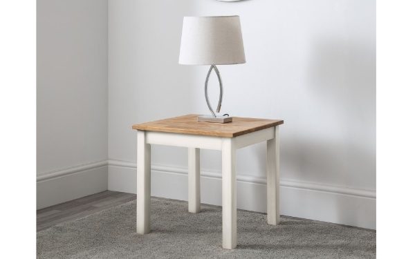 Small wooden table with a white base against a plain wall