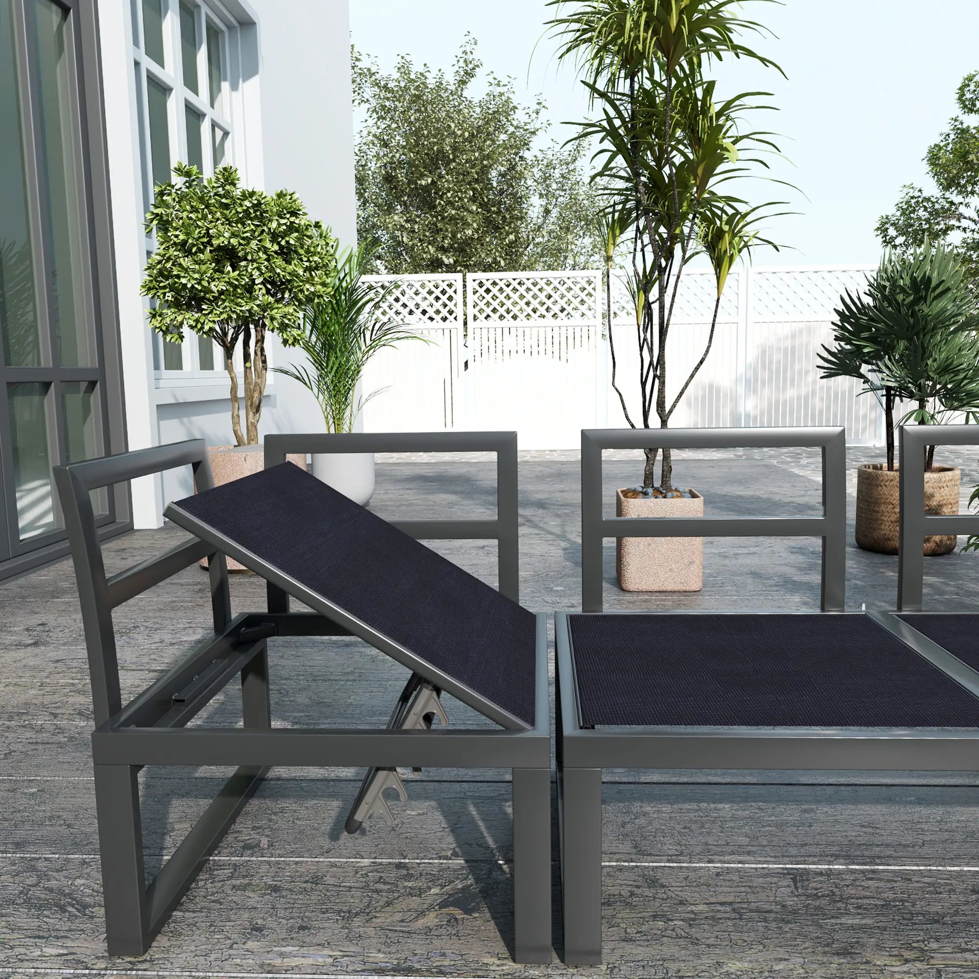 Outdoor patio furniture set with black cushions on a wooden deck.