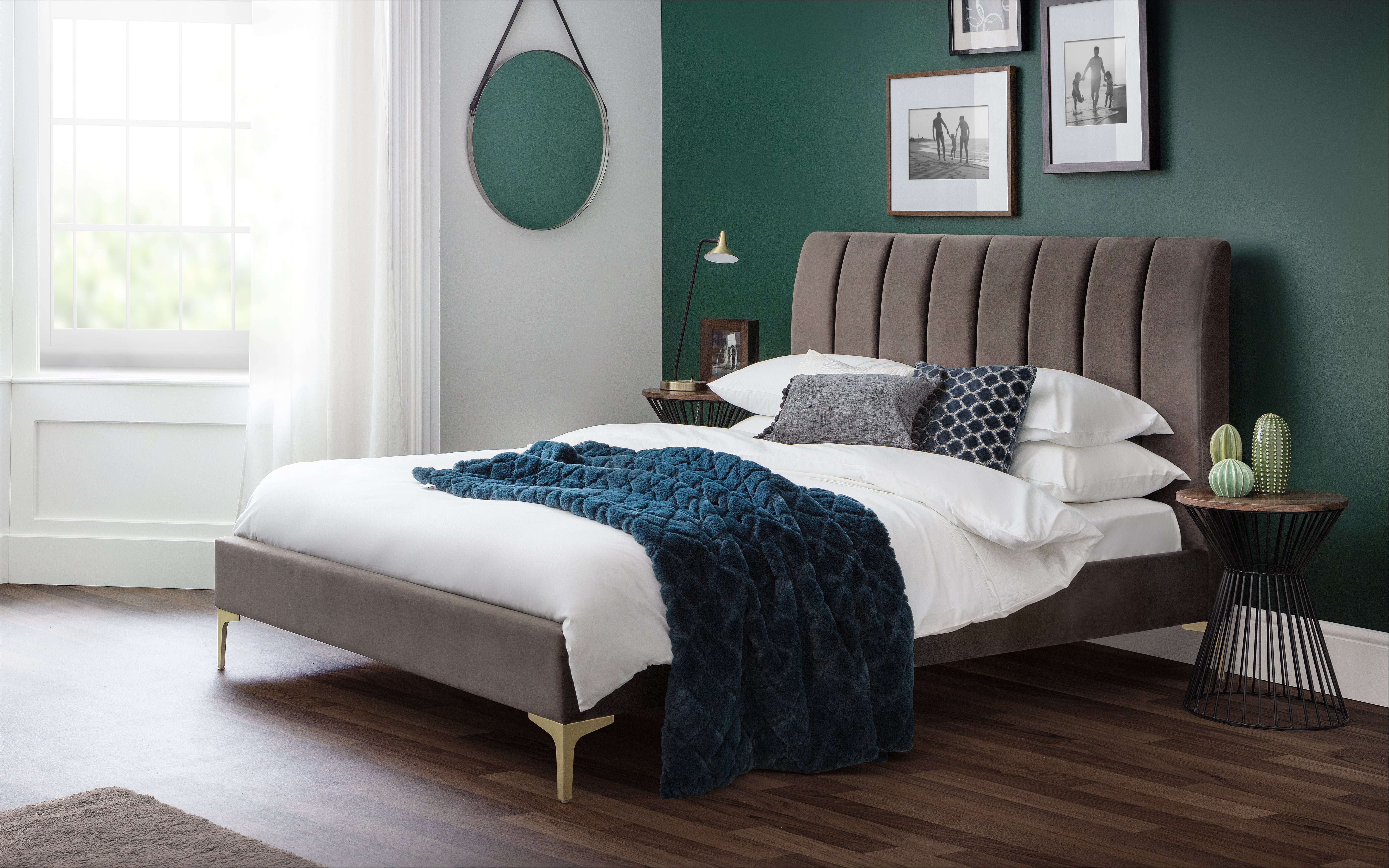 Modern bedroom with a gray upholstered bed, white bedding, and decorative pillows.