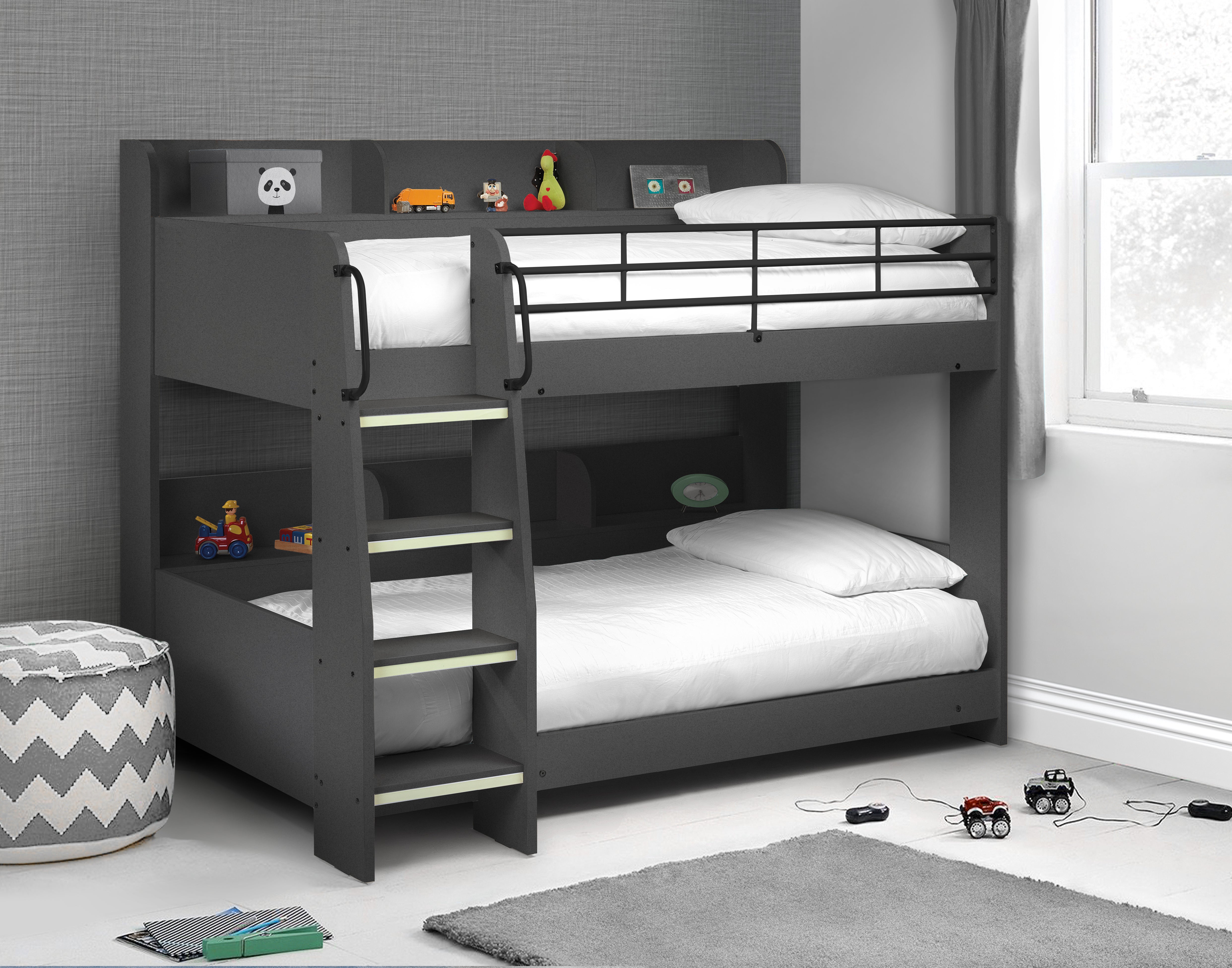 Gray bunk bed with white bedding in a room with toys and a rug.